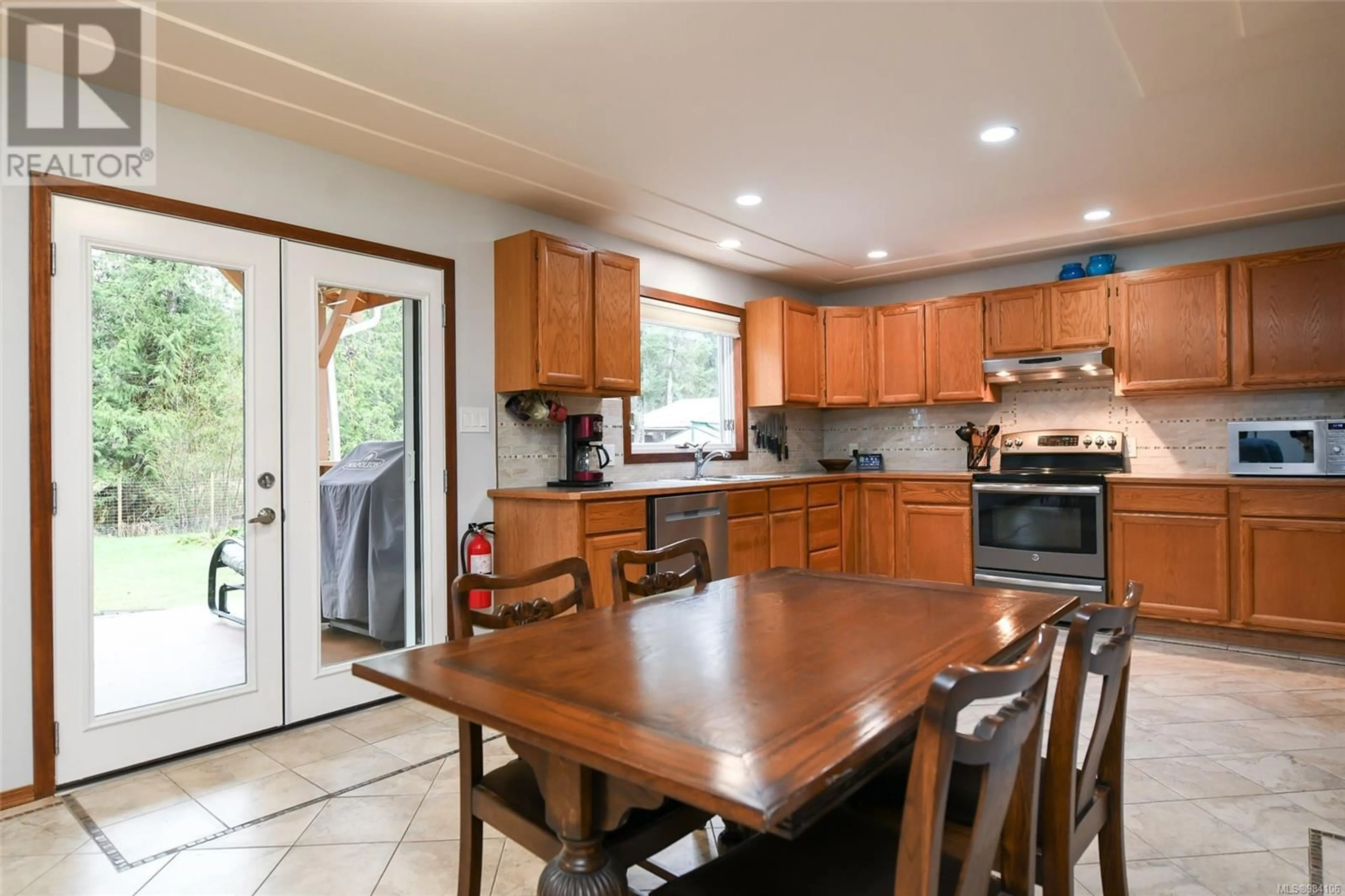 Open concept kitchen, ceramic/tile floor for 385 Bates Dr, Fanny Bay British Columbia V0R1W0