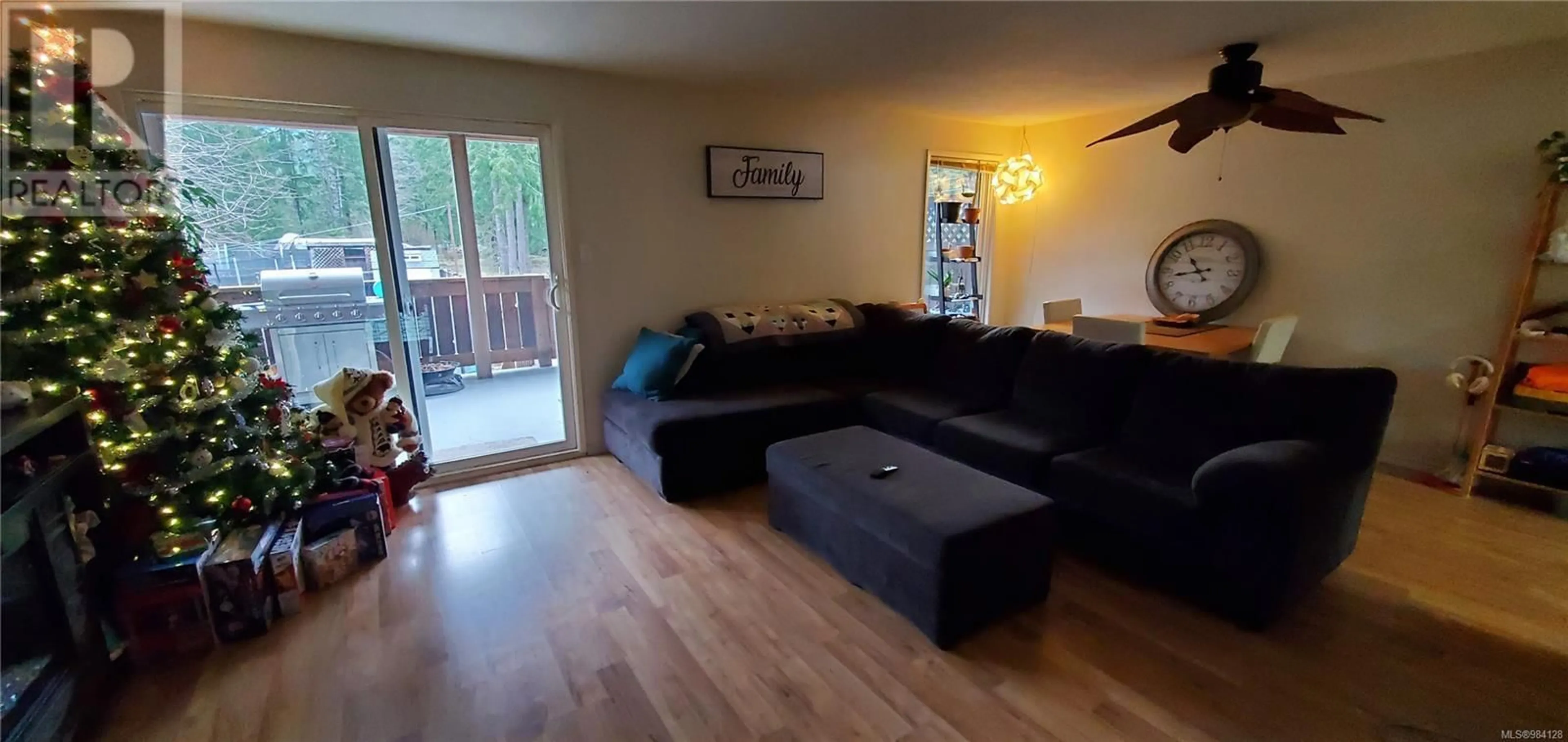 Living room with furniture, wood/laminate floor for 477 Nootka Dr, Gold River British Columbia V0P1G0