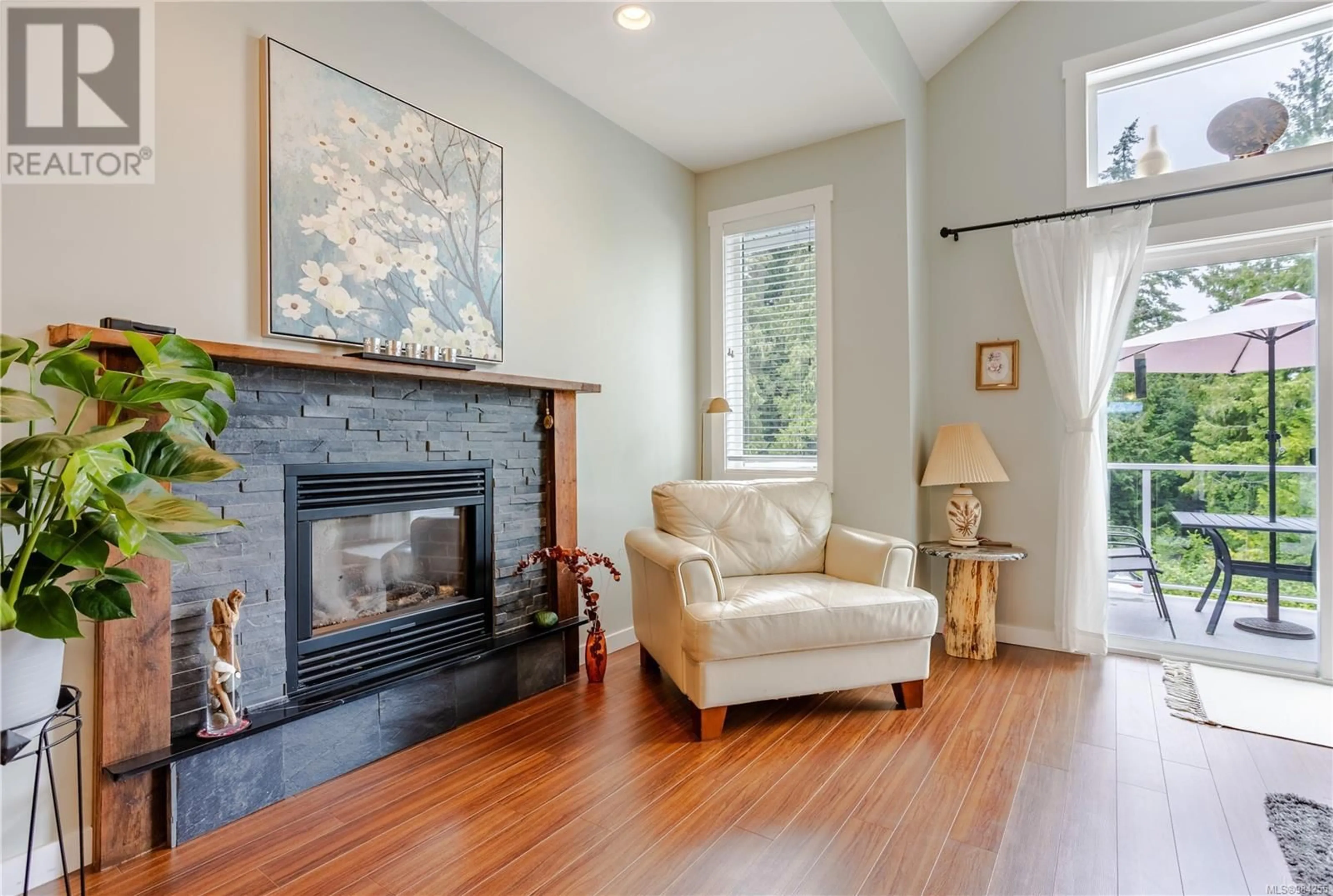 Living room with furniture, wood/laminate floor for 5727 Bradbury Rd, Nanaimo British Columbia V9T0B6