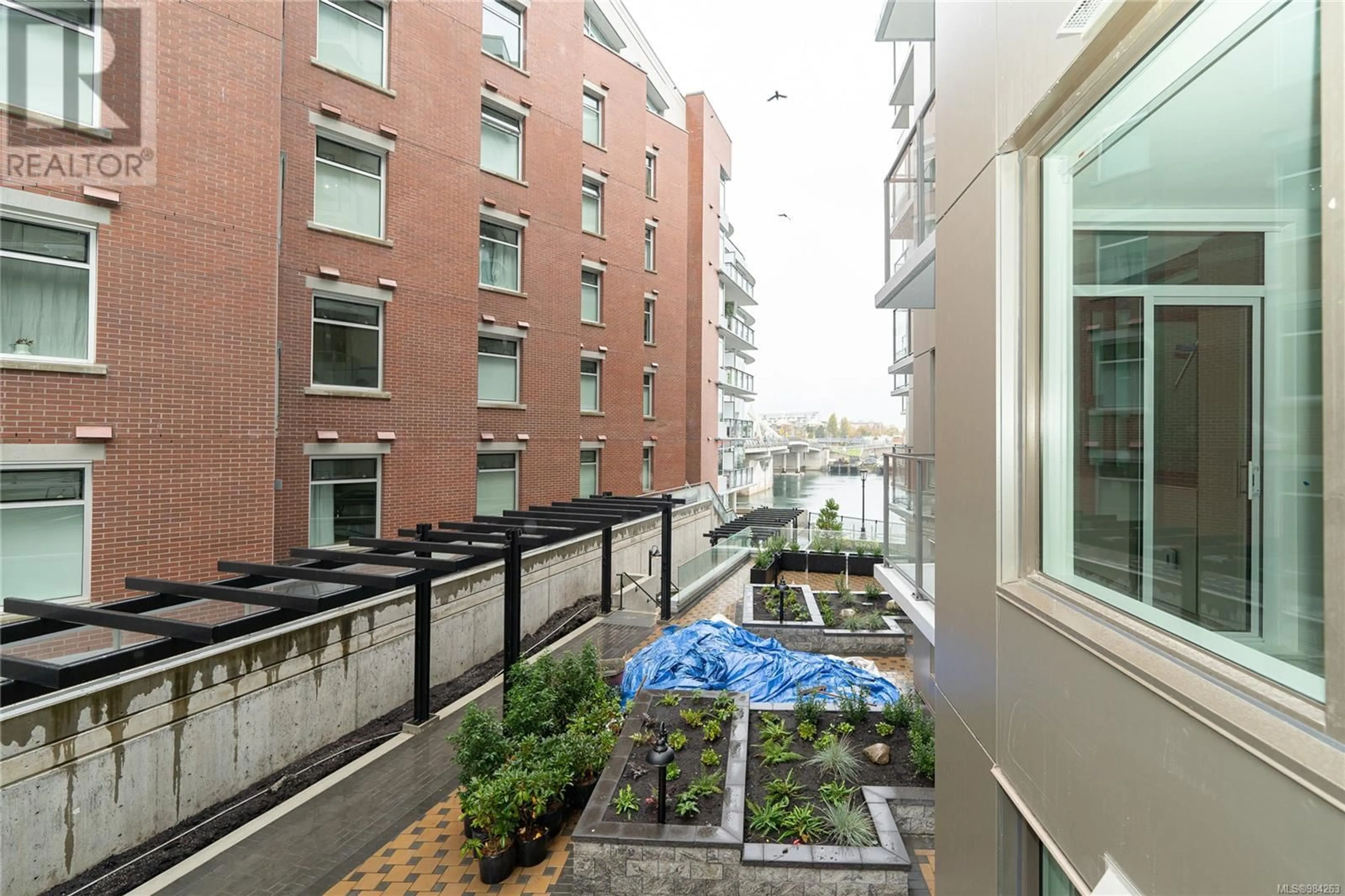 Patio, city buildings view from balcony for 408 1628 Store St, Victoria British Columbia V8W0H1