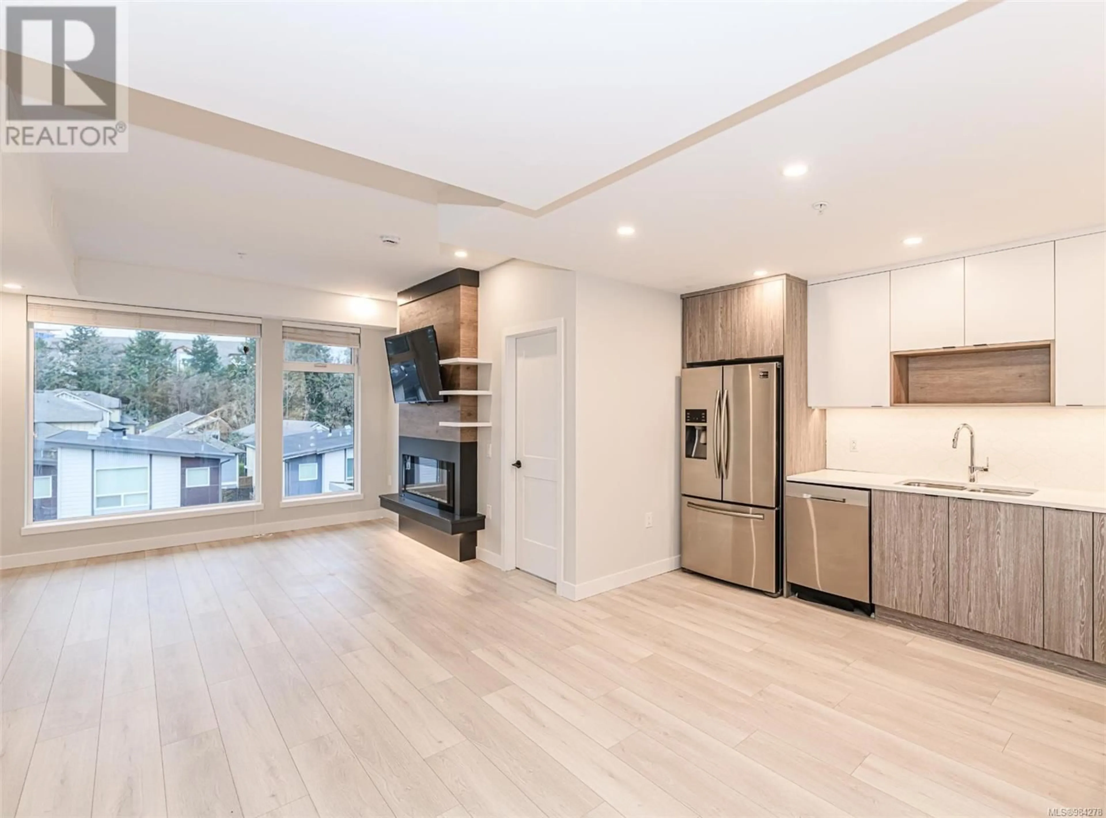 Open concept kitchen, wood/laminate floor for 414 950 Whirlaway Cres, Langford British Columbia V9B6W6