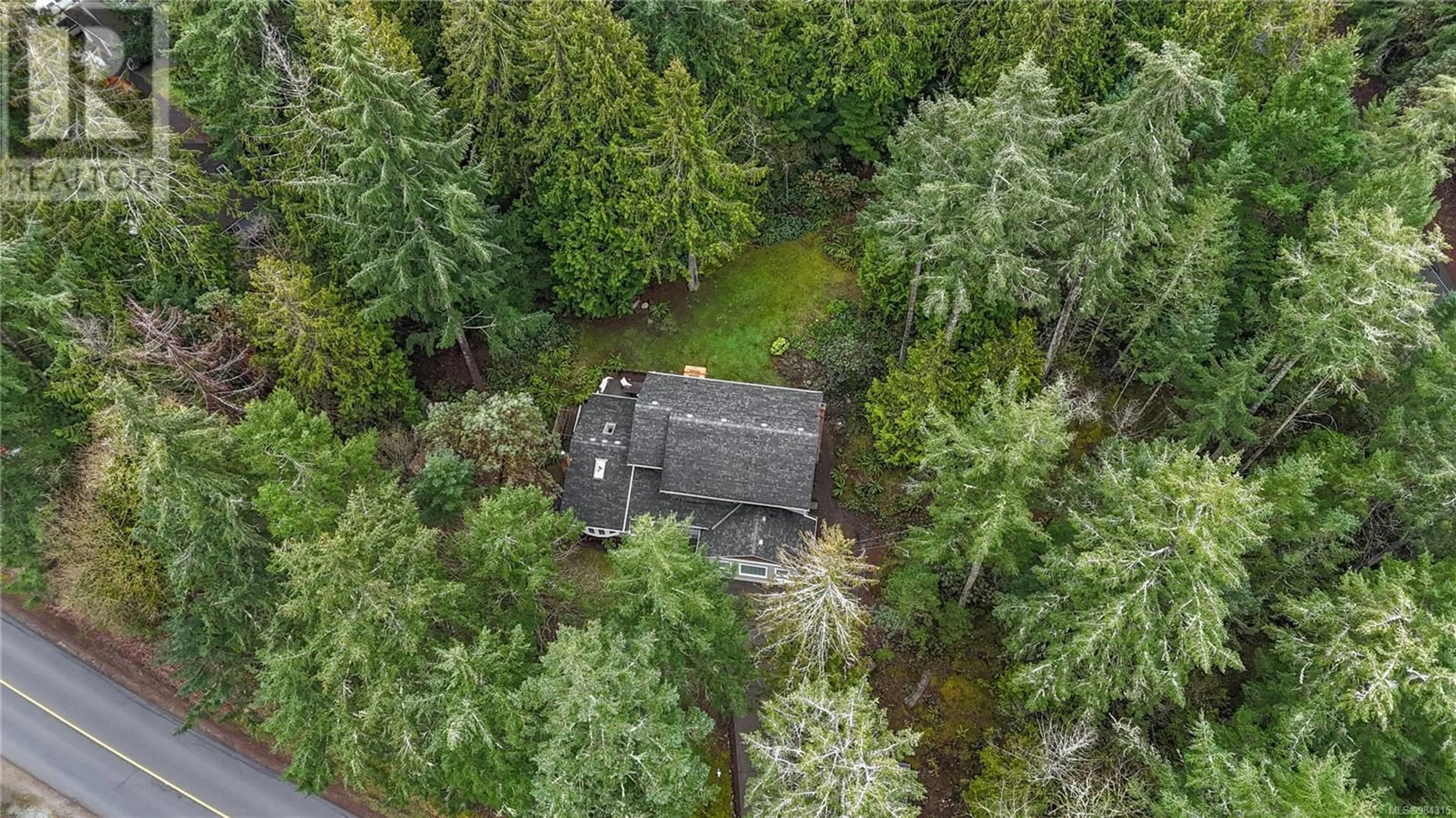 A pic from outside/outdoor area/front of a property/back of a property/a pic from drone, forest/trees view for 1945 Lands End Rd, North Saanich British Columbia V8L5J2