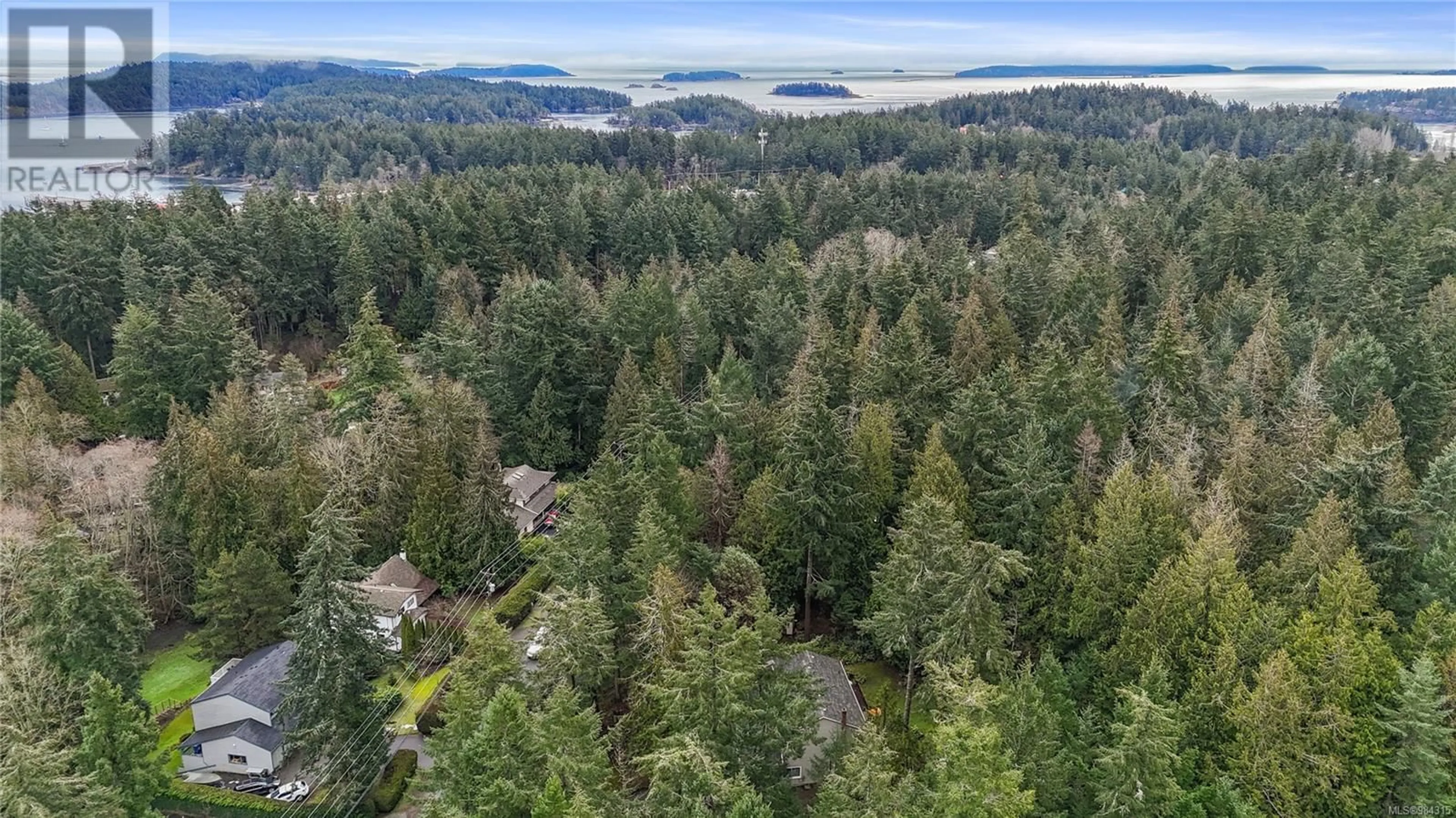 A pic from outside/outdoor area/front of a property/back of a property/a pic from drone, forest/trees view for 1945 Lands End Rd, North Saanich British Columbia V8L5J2