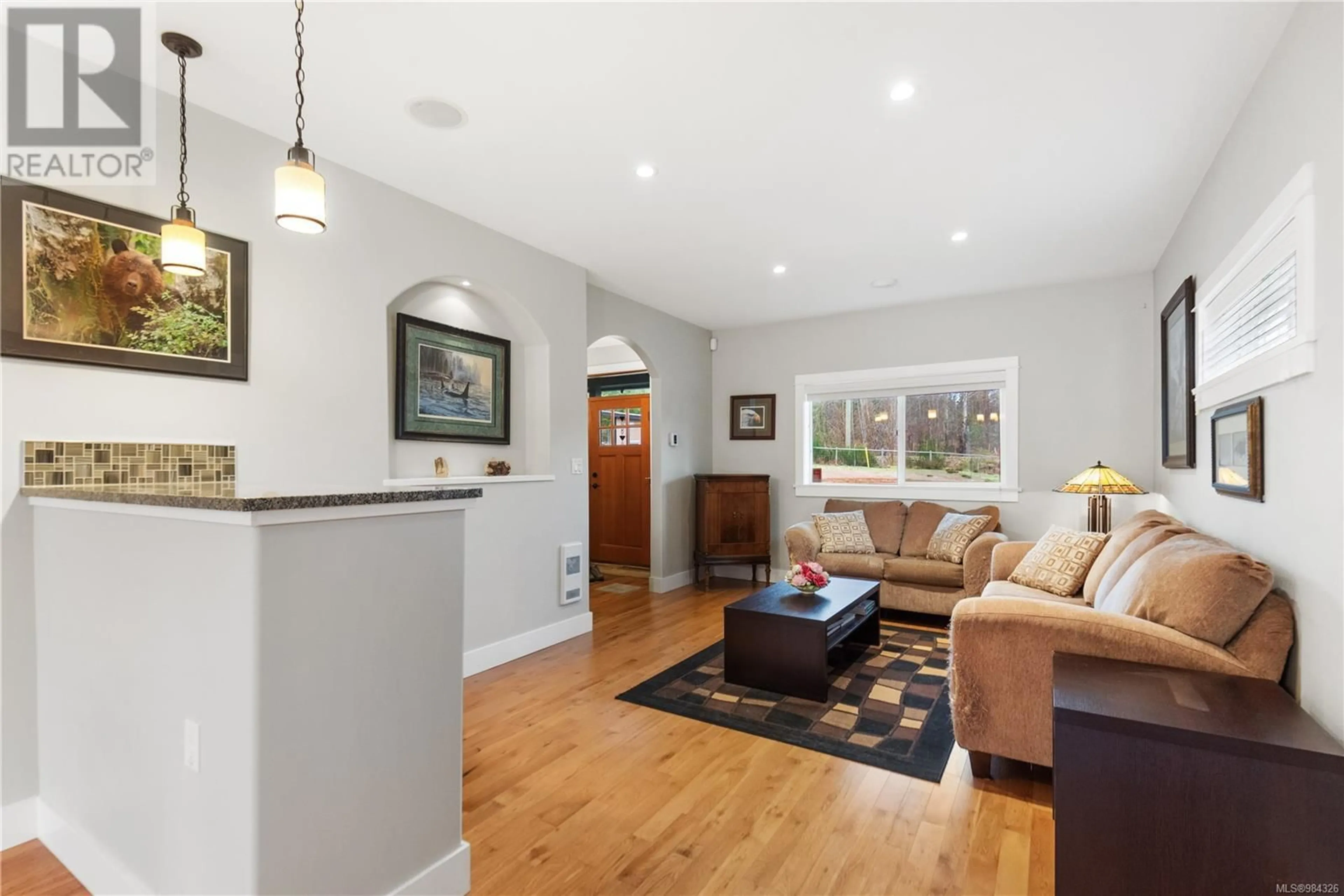 Living room with furniture, wood/laminate floor for 4380 Inwood Creek Rd, Duncan British Columbia V9L6H2