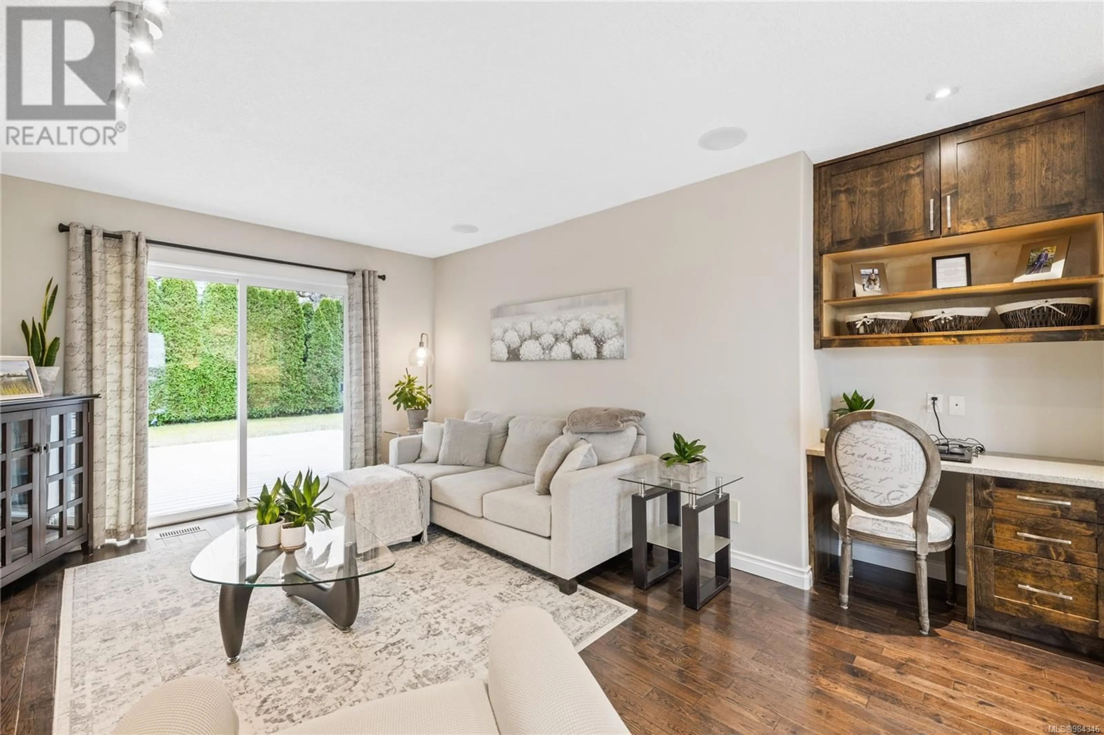 Living room with furniture, wood/laminate floor for 6593 Pelican Way, Nanaimo British Columbia V9V1P9