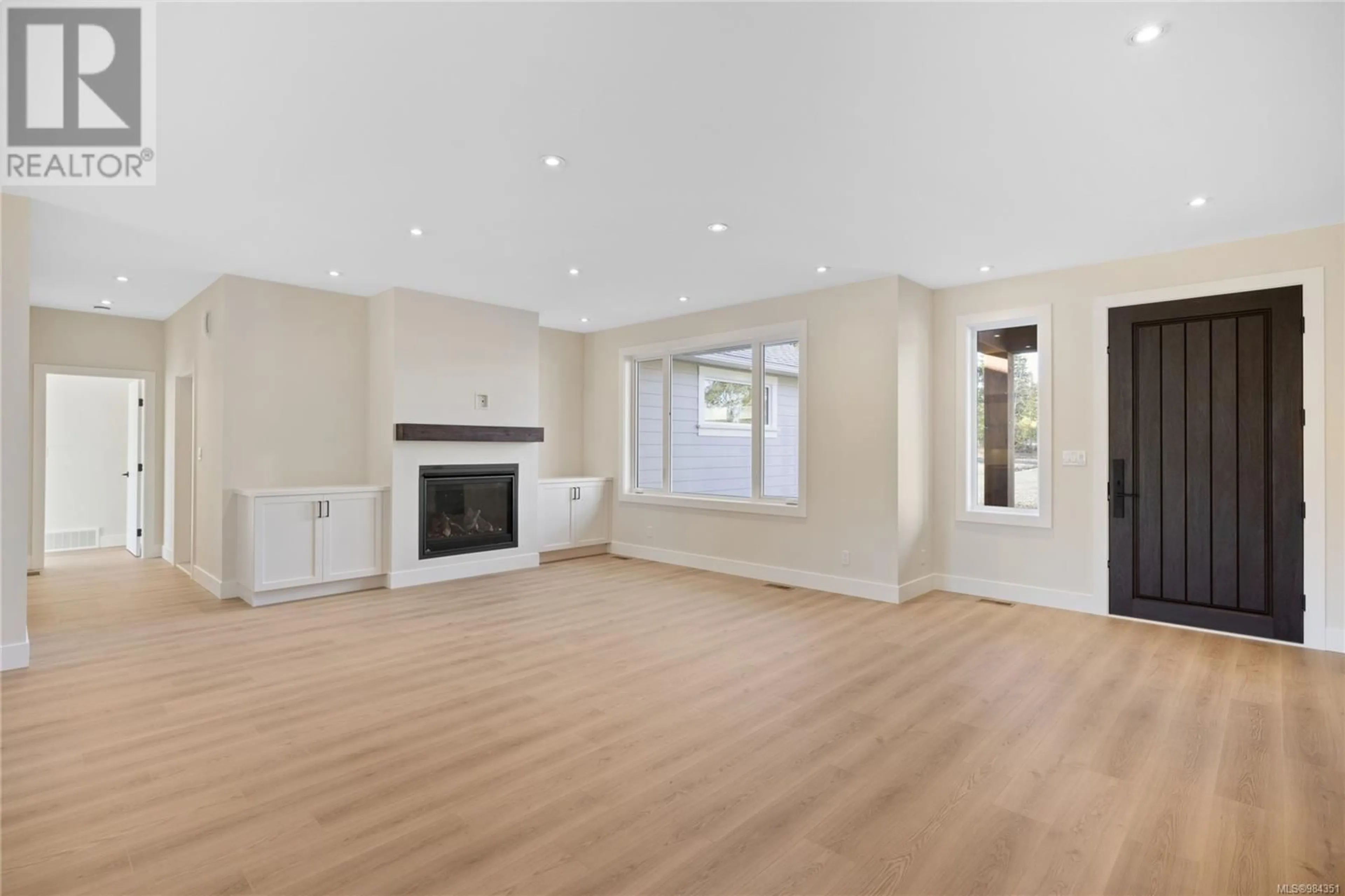 Living room with furniture, wood/laminate floor for 1230 / 1232 Station Rd, Coombs British Columbia V0R1M0