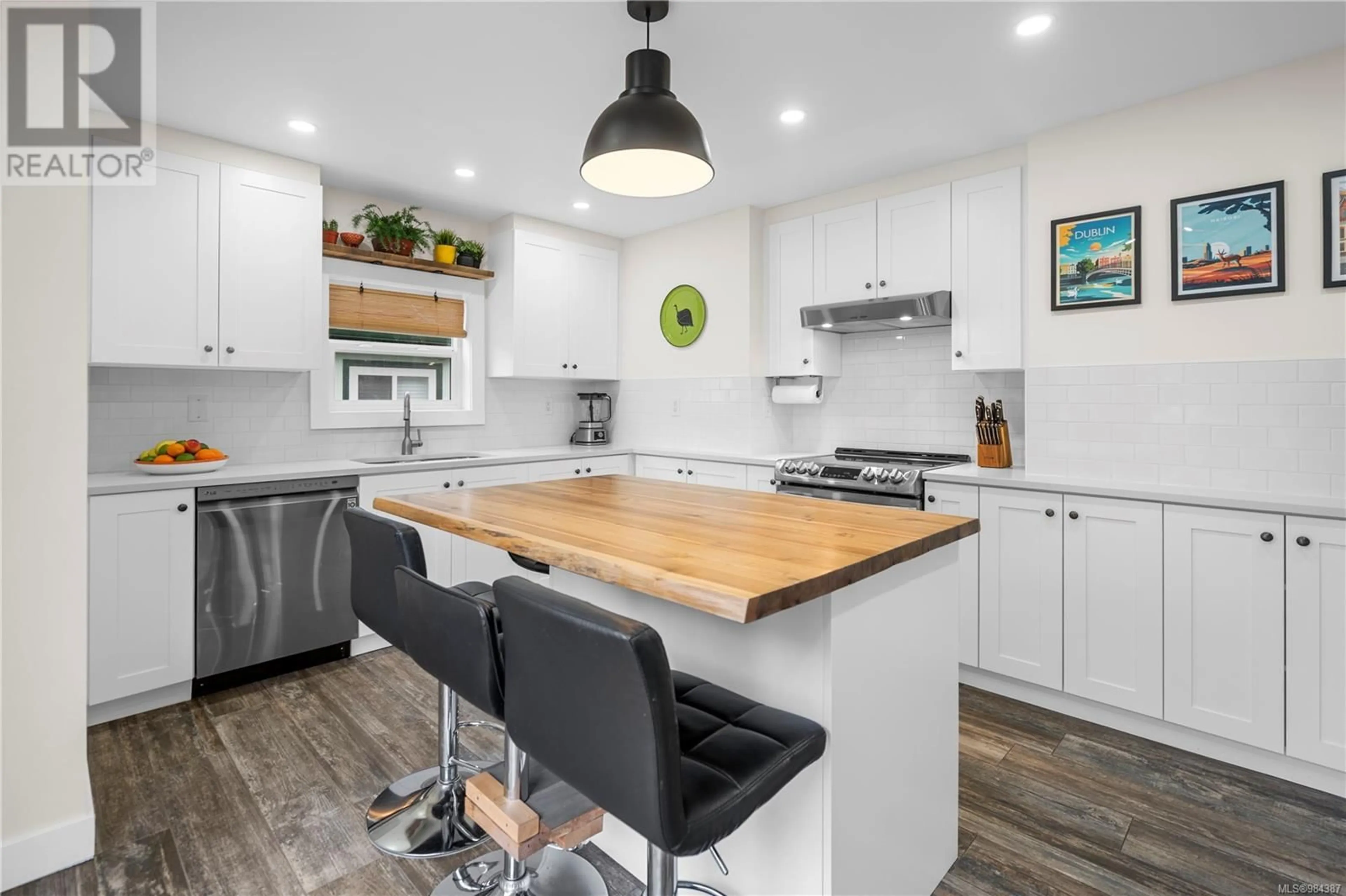 Open concept kitchen, wood/laminate floor for 3165 Donald St, Saanich British Columbia V9A1Y4