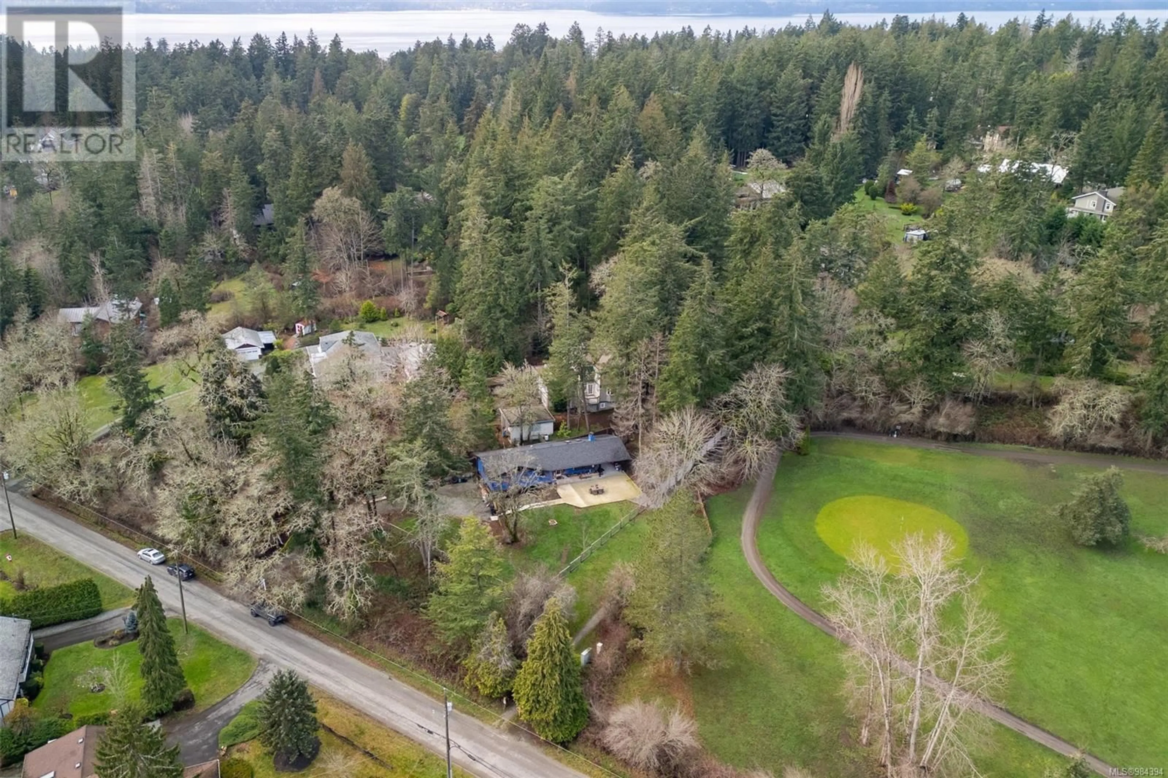 A pic from outside/outdoor area/front of a property/back of a property/a pic from drone, forest/trees view for 814 Ardmore Dr, North Saanich British Columbia V8L5G2