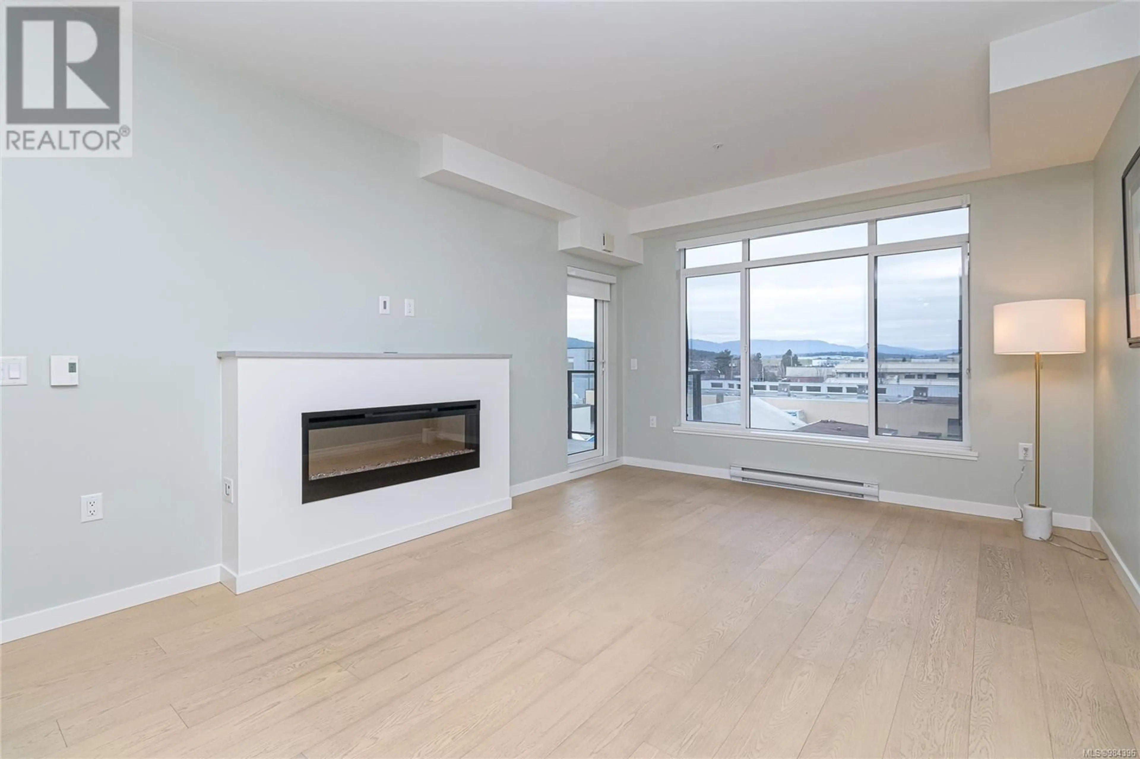 Living room with furniture, wood/laminate floor for 405 9775 Fourth St, Sidney British Columbia V8L2Z8