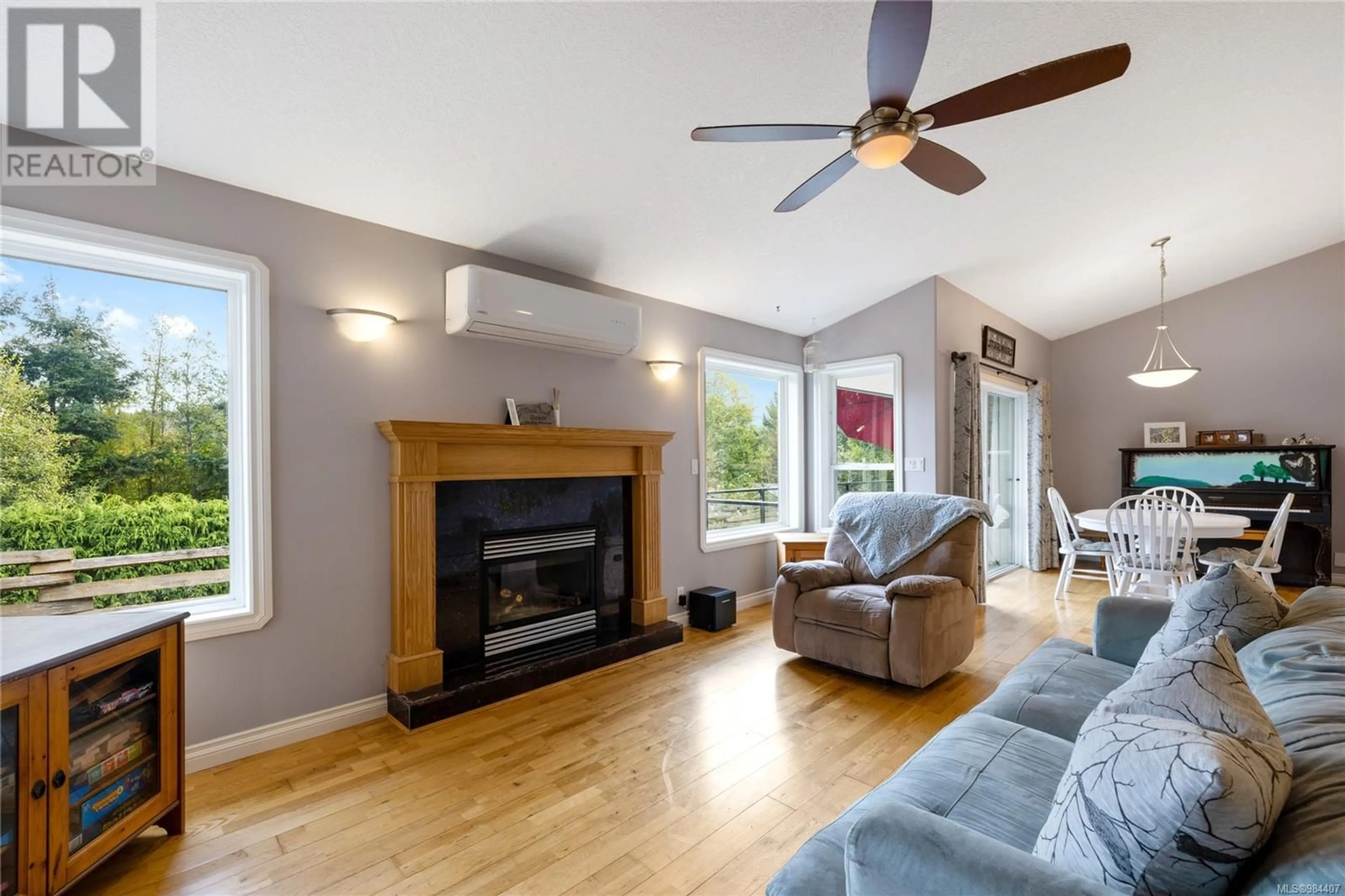 Living room with furniture, wood/laminate floor for 1840 Martini Way, Qualicum Beach British Columbia V9K2S3