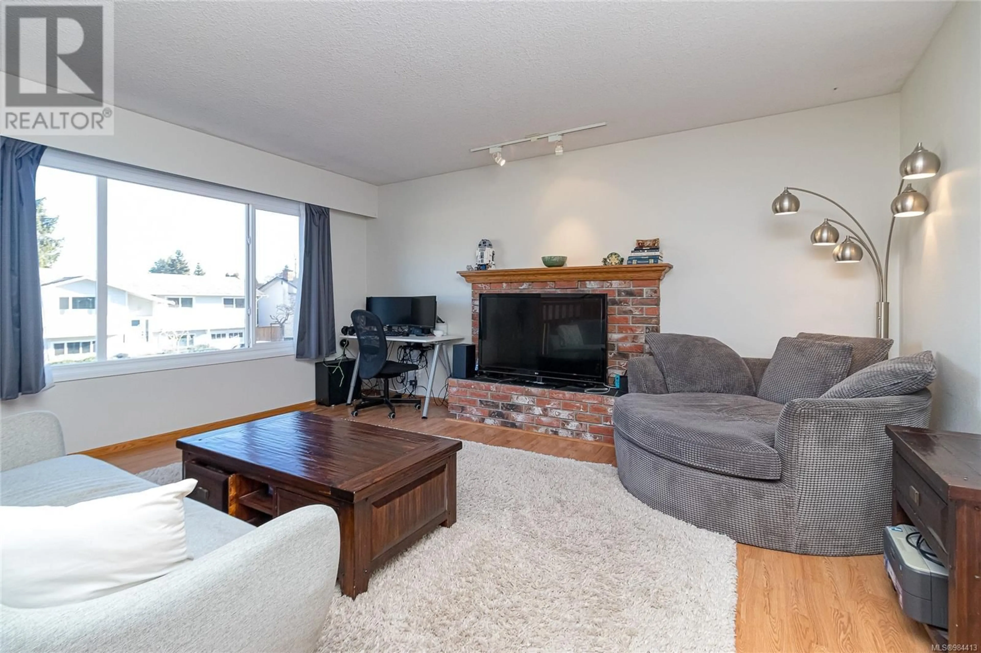 Living room with furniture, wood/laminate floor for 4378 Fieldmont Pl, Saanich British Columbia V8N4Z3