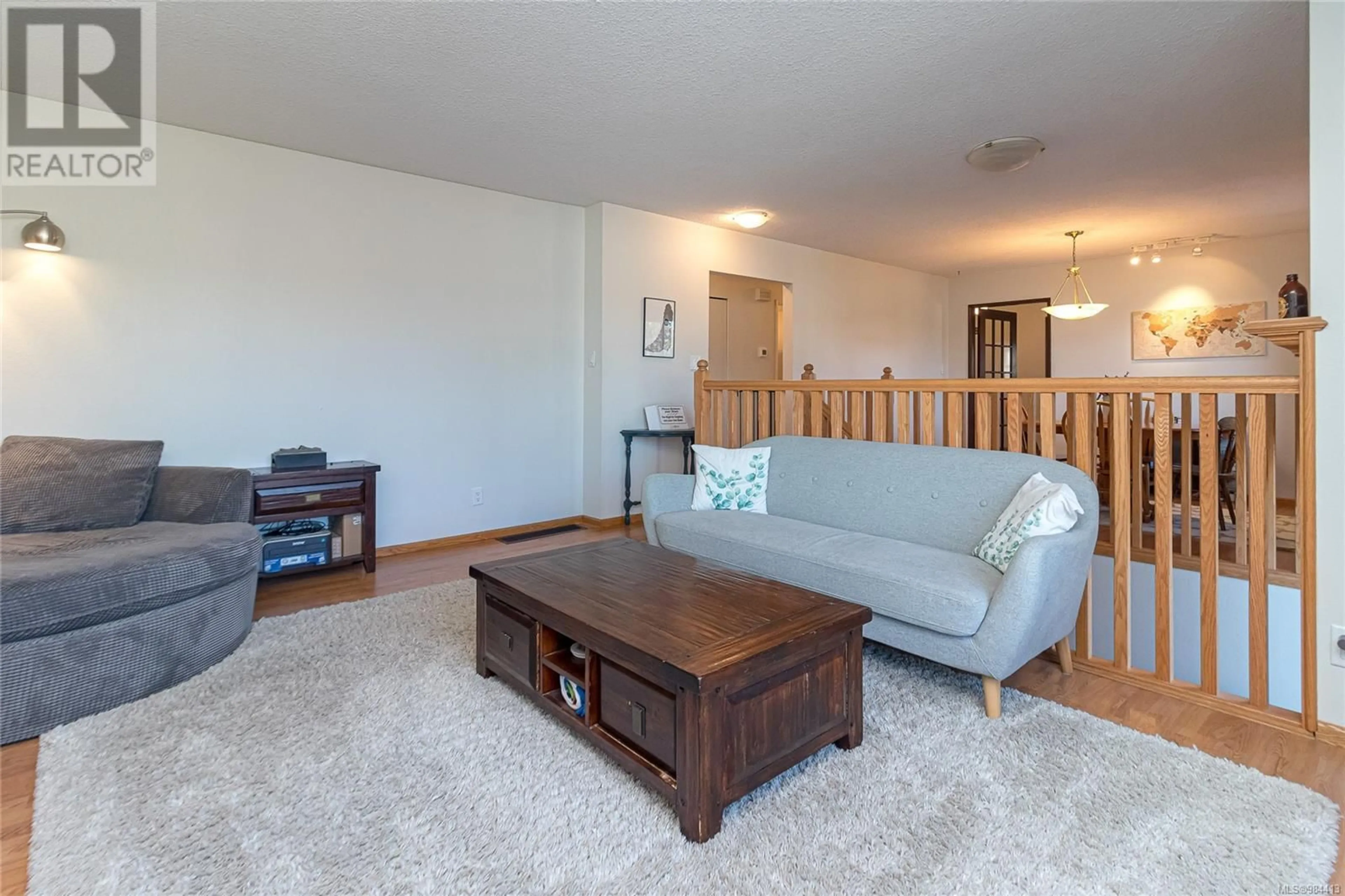 Living room with furniture, wood/laminate floor for 4378 Fieldmont Pl, Saanich British Columbia V8N4Z3