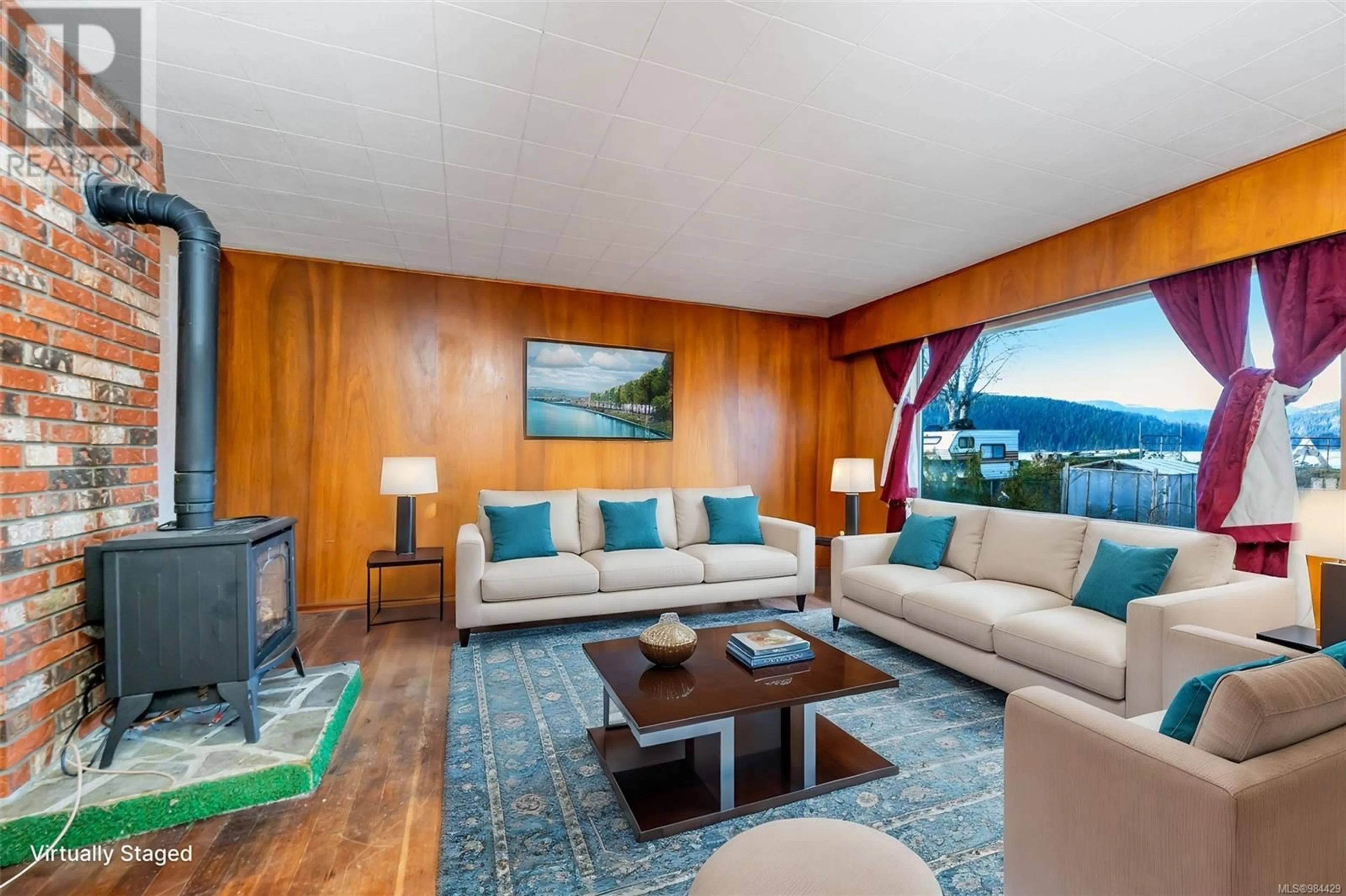 Living room with furniture, wood/laminate floor for 6672 Queesto Dr, Port Renfrew British Columbia V0S1N0