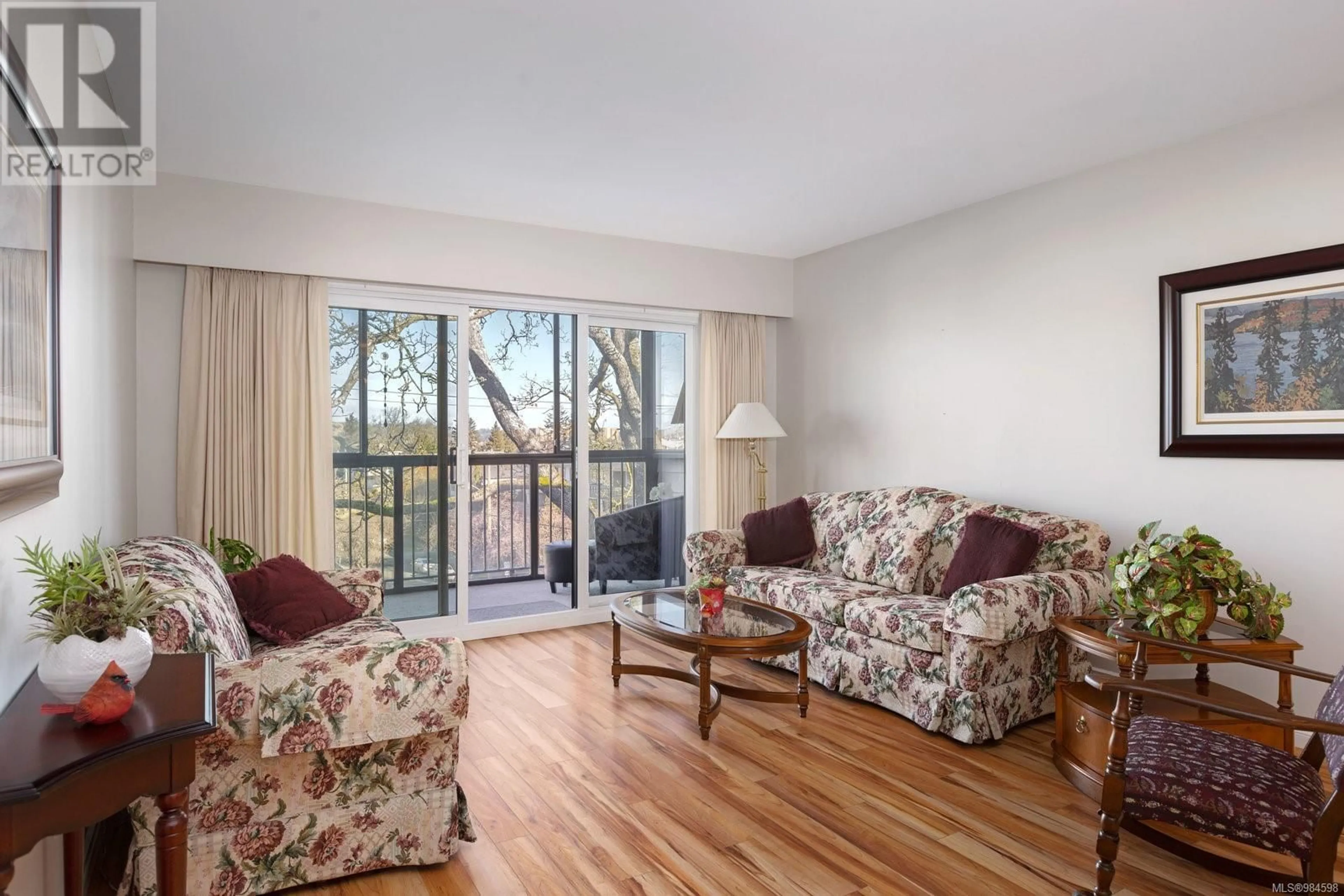 Living room with furniture, wood/laminate floor for 405 1665 Oak Bay Ave, Victoria British Columbia V8R1B5