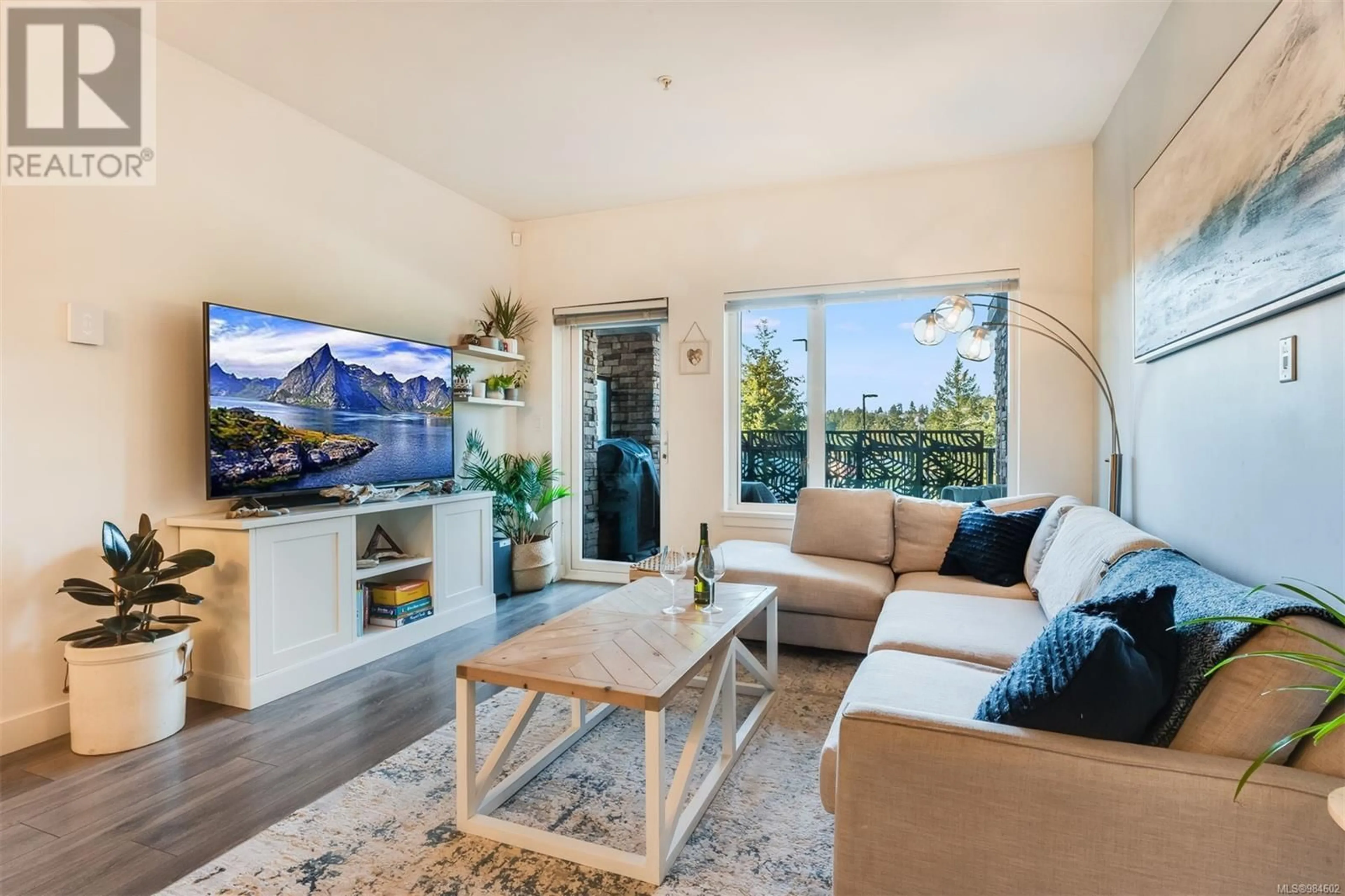 Living room with furniture, wood/laminate floor for 104 290 Wilfert Rd, View Royal British Columbia V9C0H6