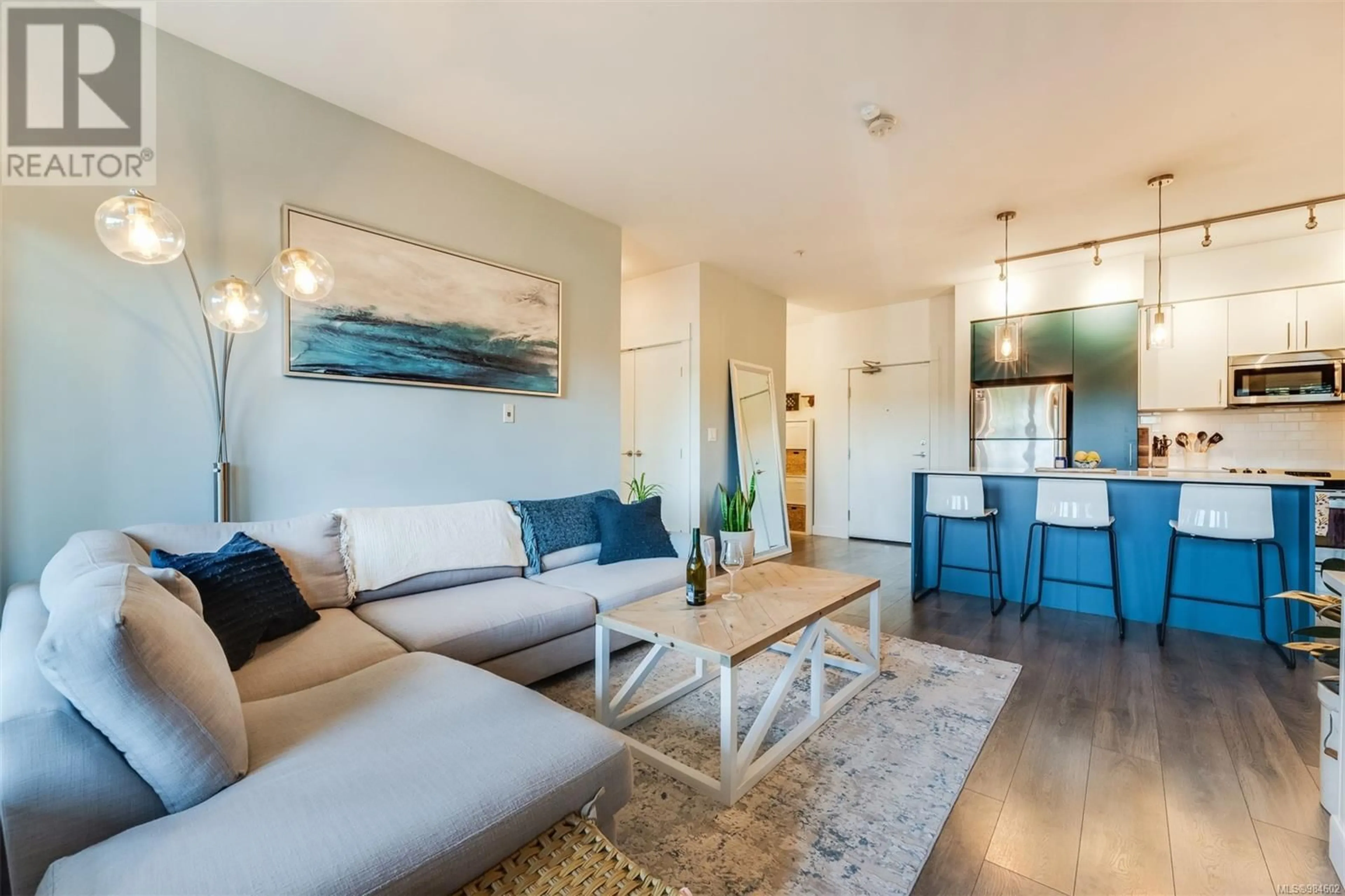 Living room with furniture, wood/laminate floor for 104 290 Wilfert Rd, View Royal British Columbia V9C0H6