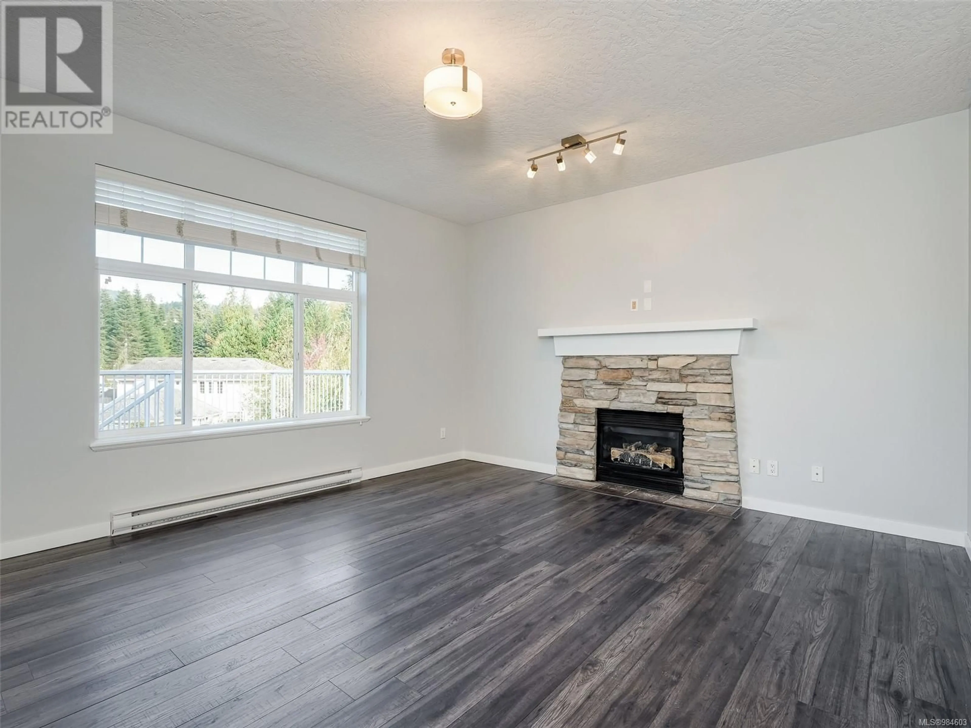 Living room with furniture, wood/laminate floor for 2305 Demamiel Pl, Sooke British Columbia V9Z0Y4