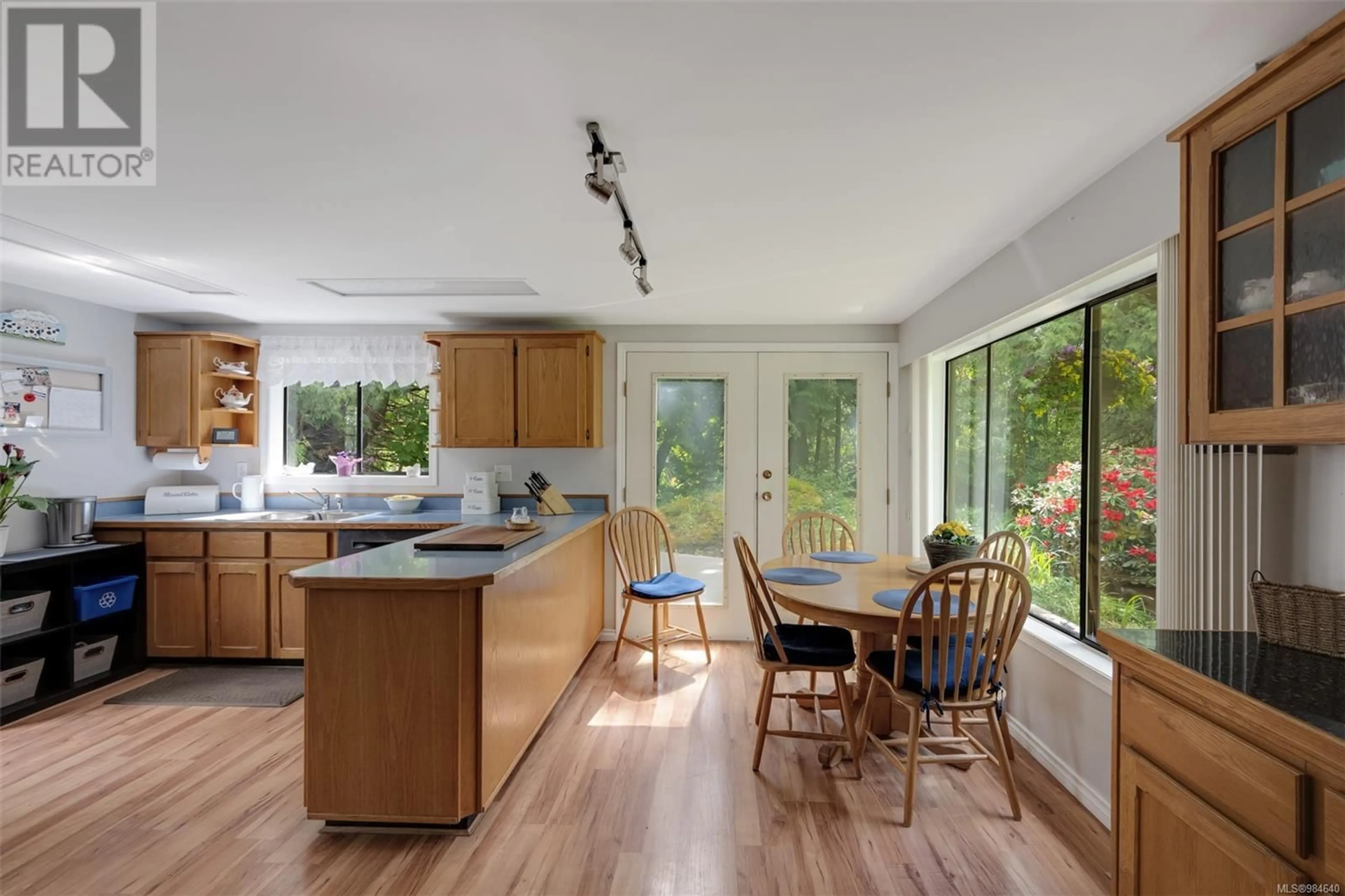 Open concept kitchen, wood/laminate floor for 734 Latoria Rd, Langford British Columbia V9C3A4