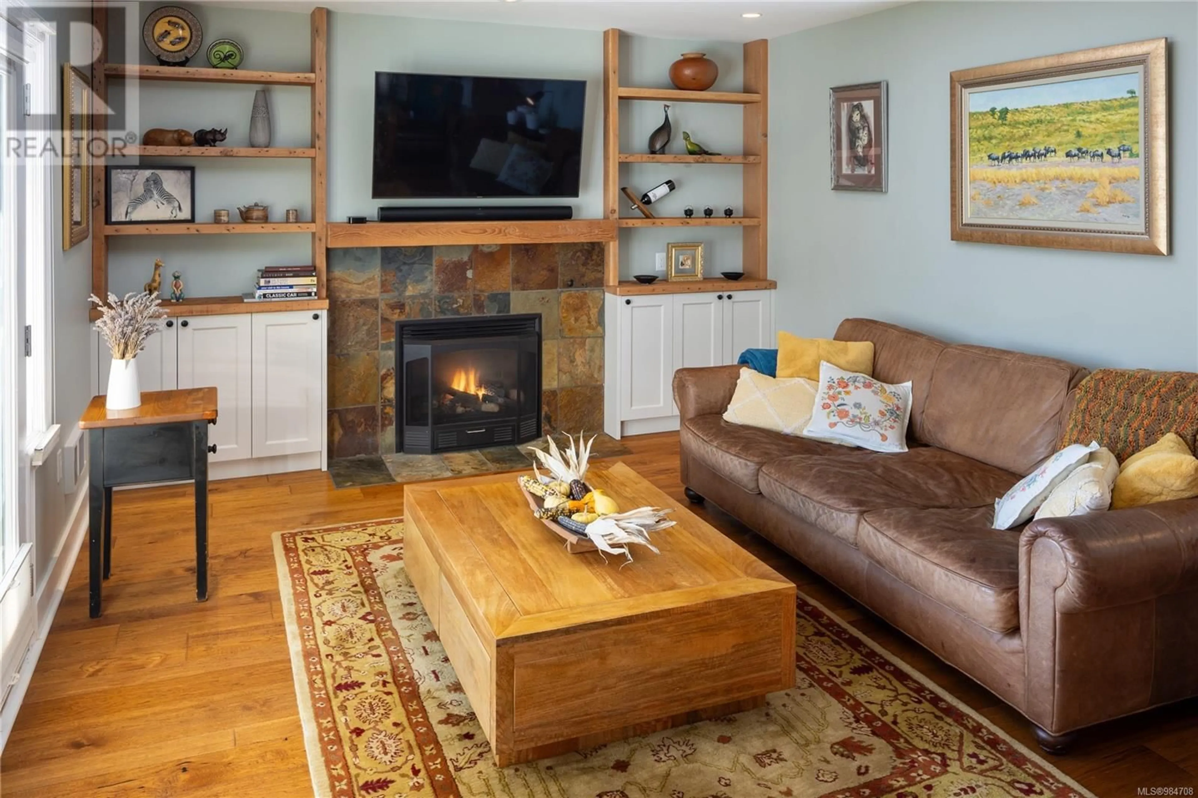 Living room with furniture, wood/laminate floor for 1494 Beach Dr, Oak Bay British Columbia V8S2N9