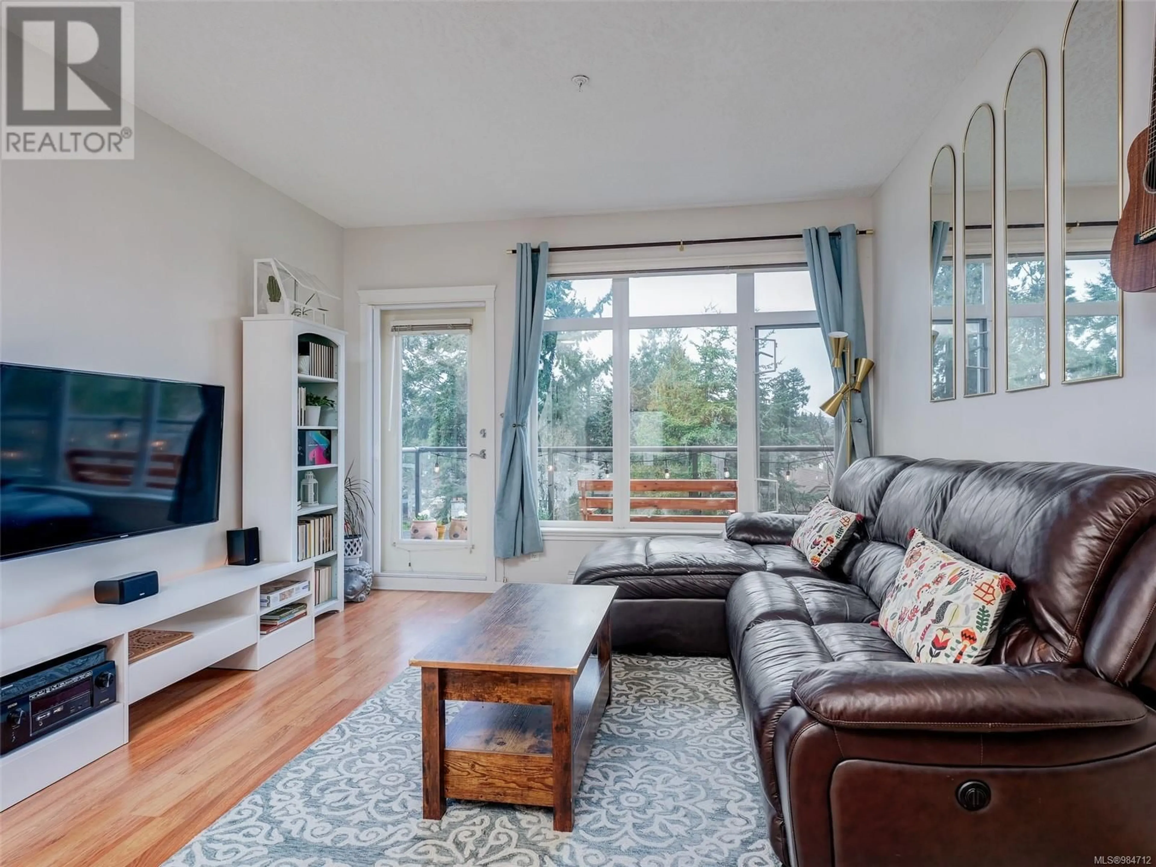 Living room with furniture, wood/laminate floor for 406 2220 Sooke Rd, Colwood British Columbia V9B0G9