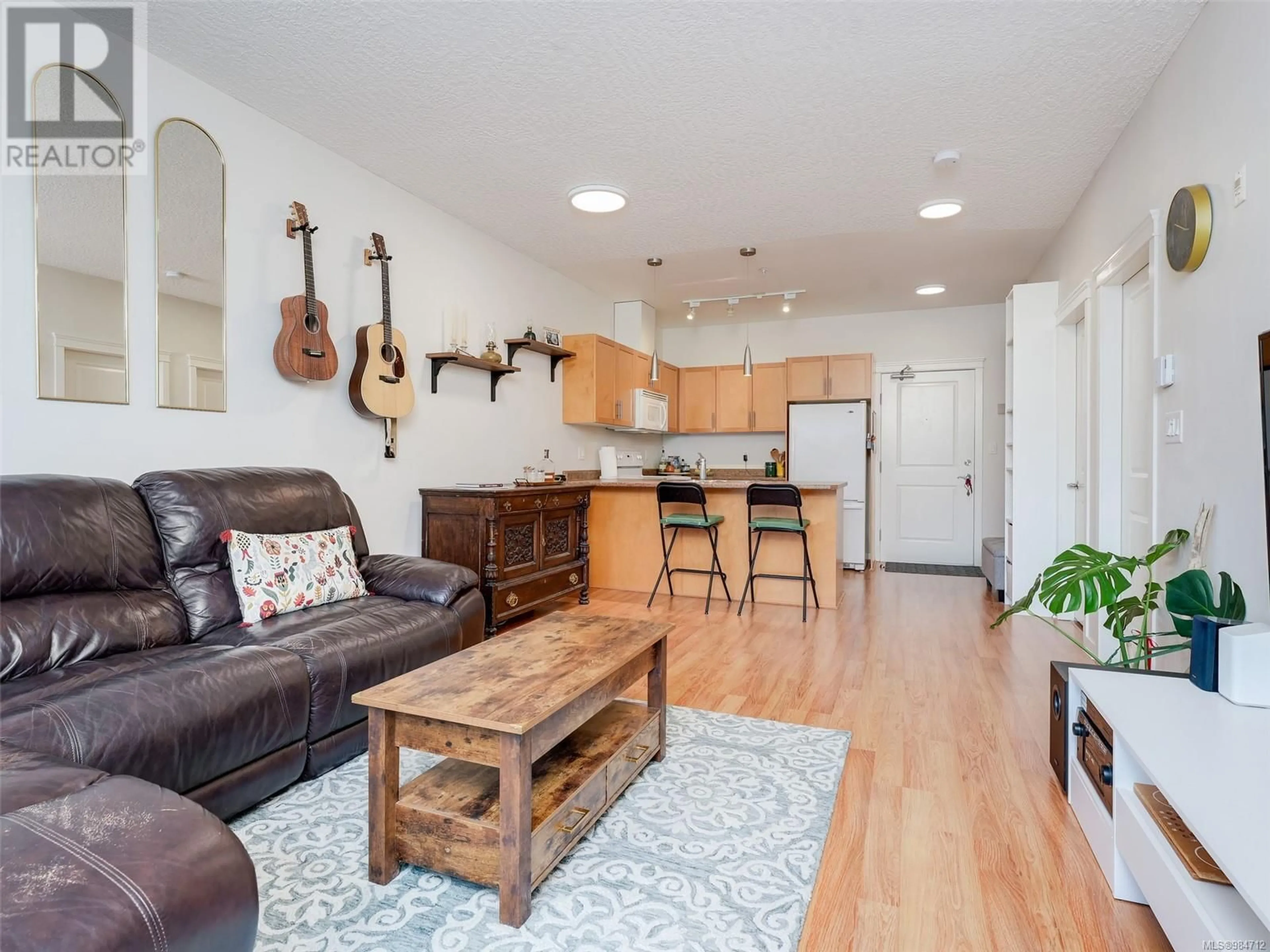 Living room with furniture, wood/laminate floor for 406 2220 Sooke Rd, Colwood British Columbia V9B0G9