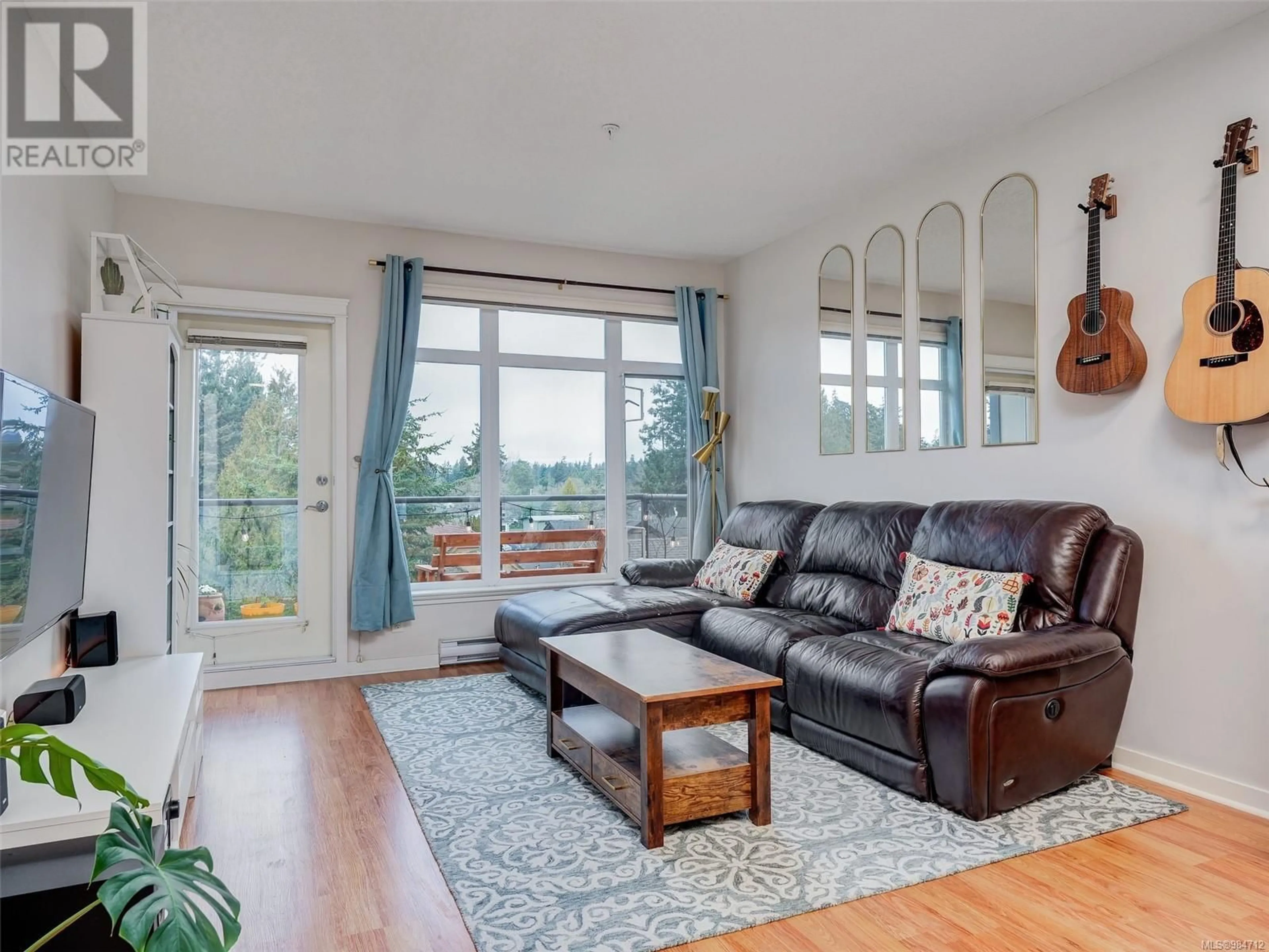 Living room with furniture, wood/laminate floor for 406 2220 Sooke Rd, Colwood British Columbia V9B0G9