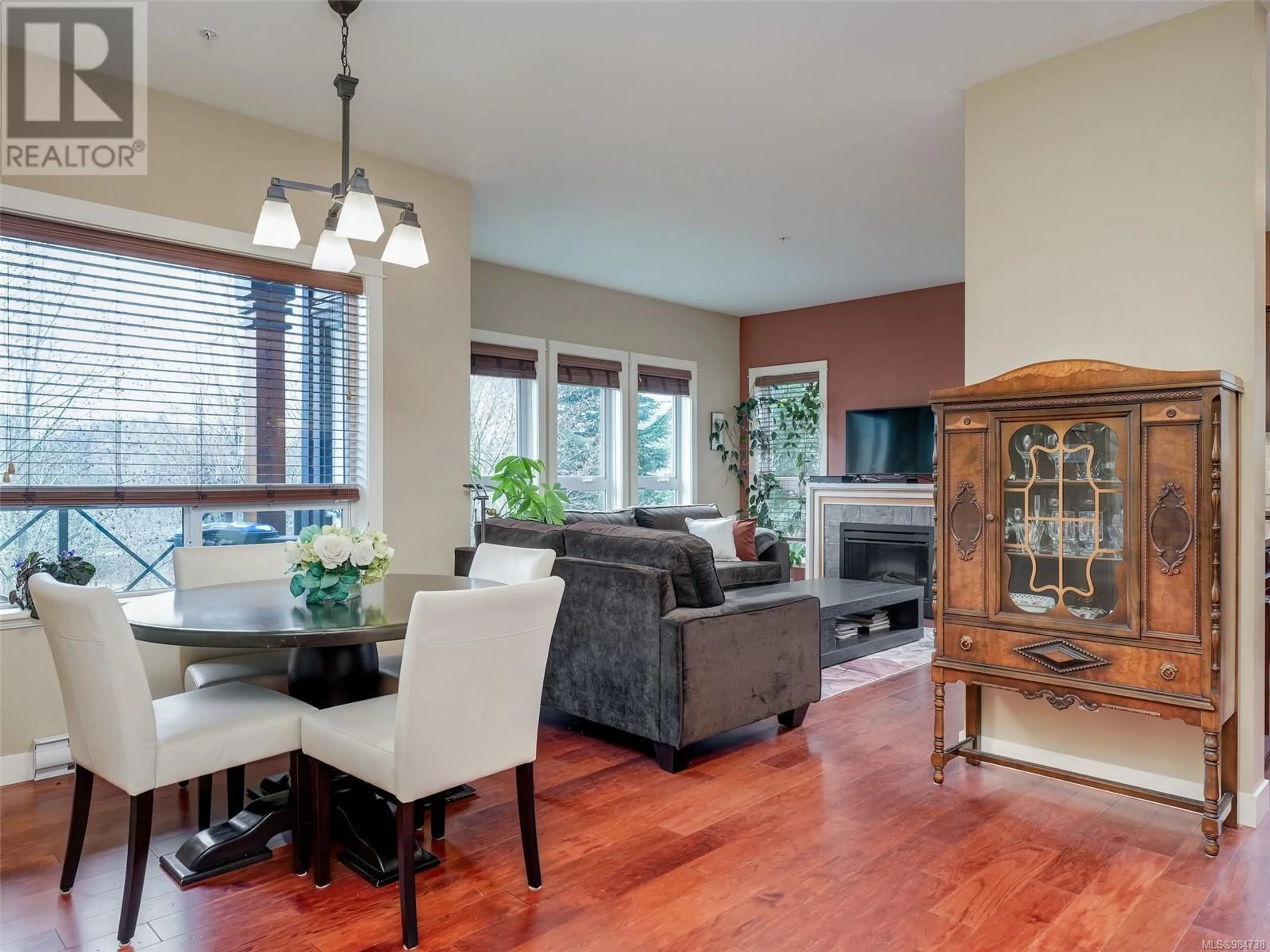 Living room with furniture, wood/laminate floor for 206 201 Nursery Hill Dr, View Royal British Columbia V9B0H7