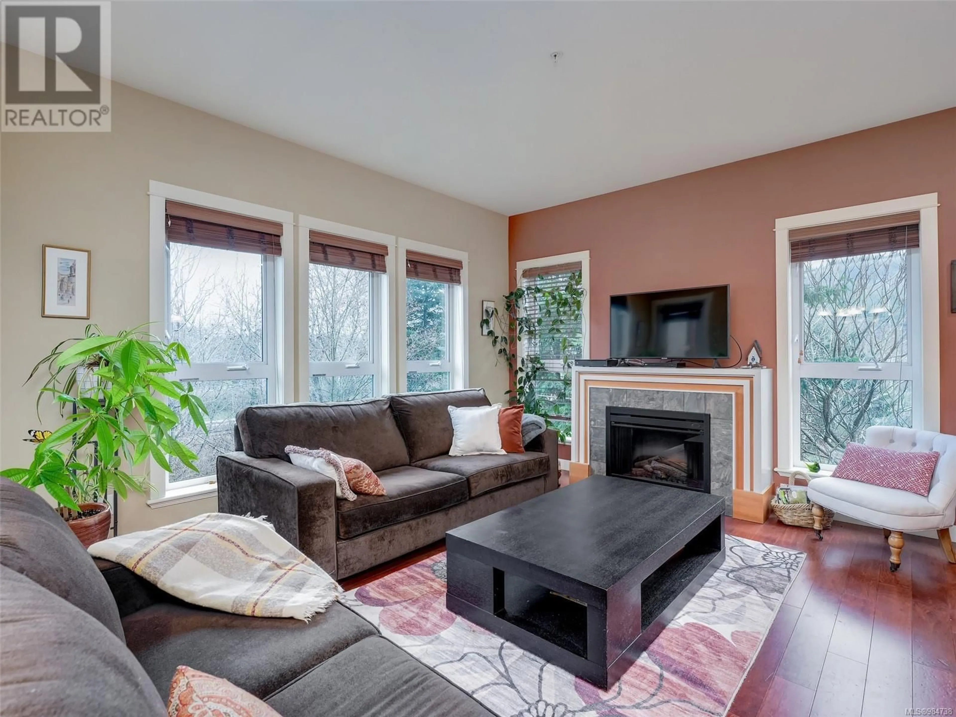 Living room with furniture, wood/laminate floor for 206 201 Nursery Hill Dr, View Royal British Columbia V9B0H7