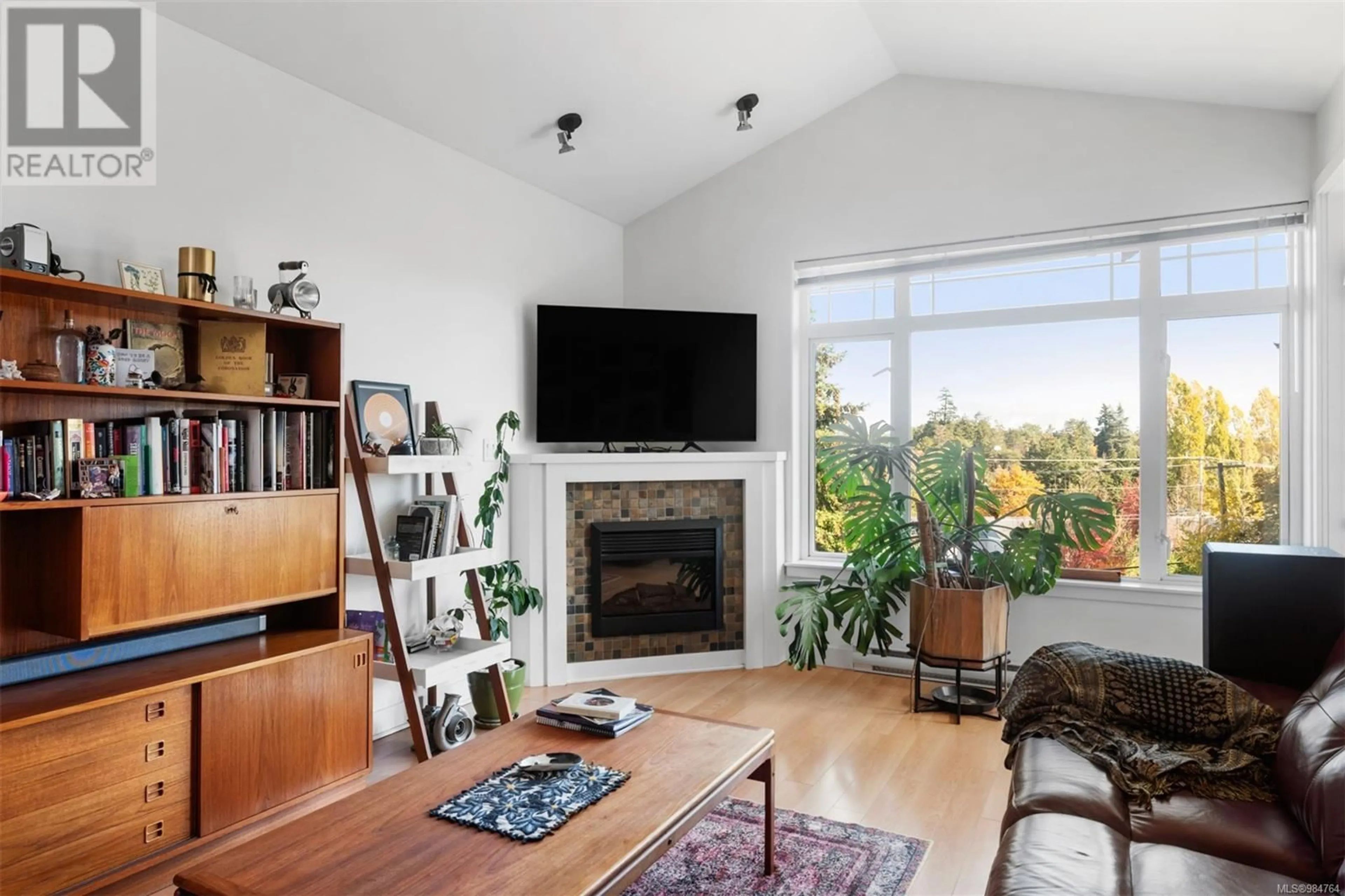 Living room with furniture, wood/laminate floor for 408E 1115 Craigflower Rd, Esquimalt British Columbia V9A7R1