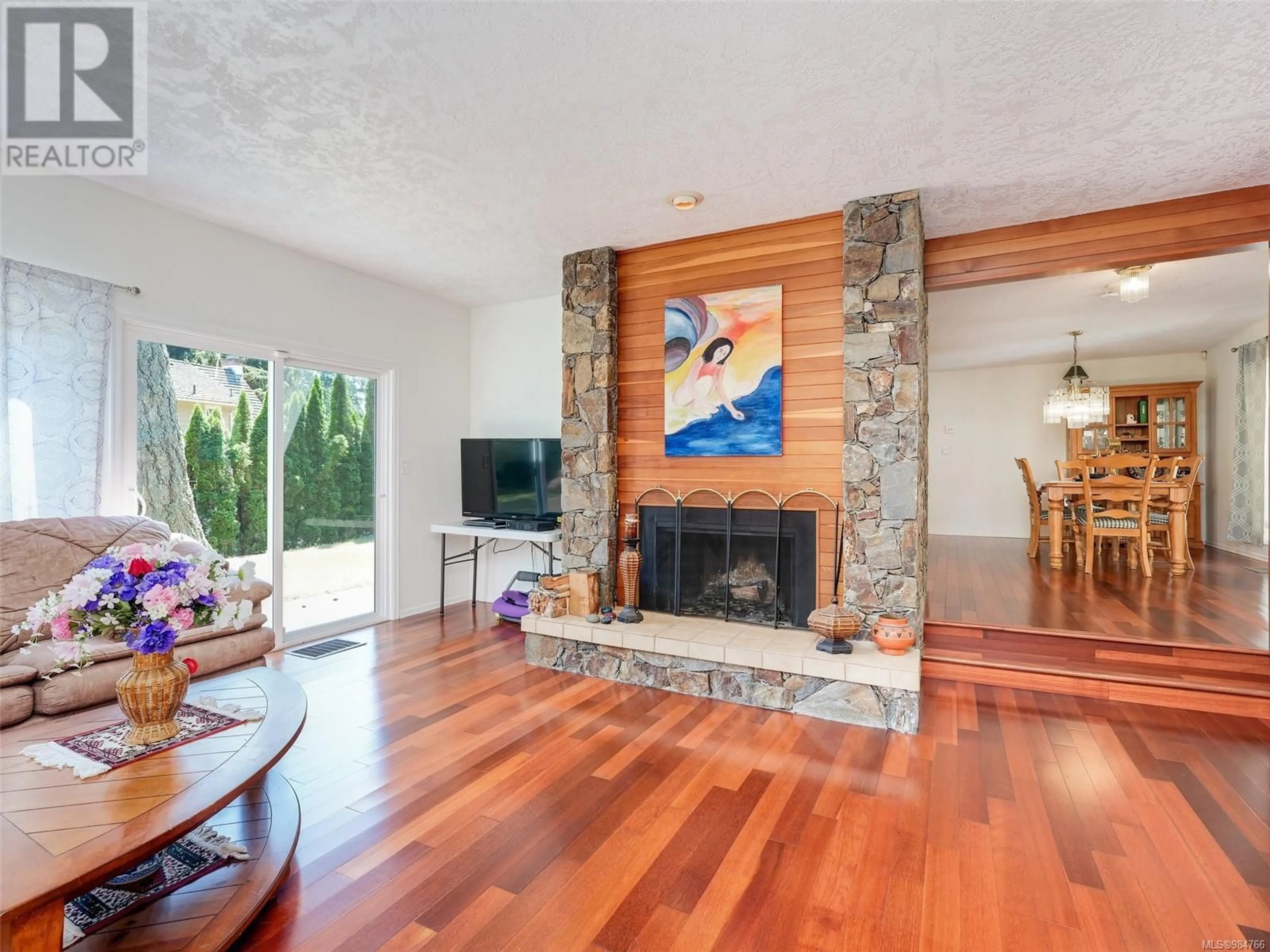 Living room with furniture, wood/laminate floor for 979 Royal Oak Dr, Saanich British Columbia V8X3T6