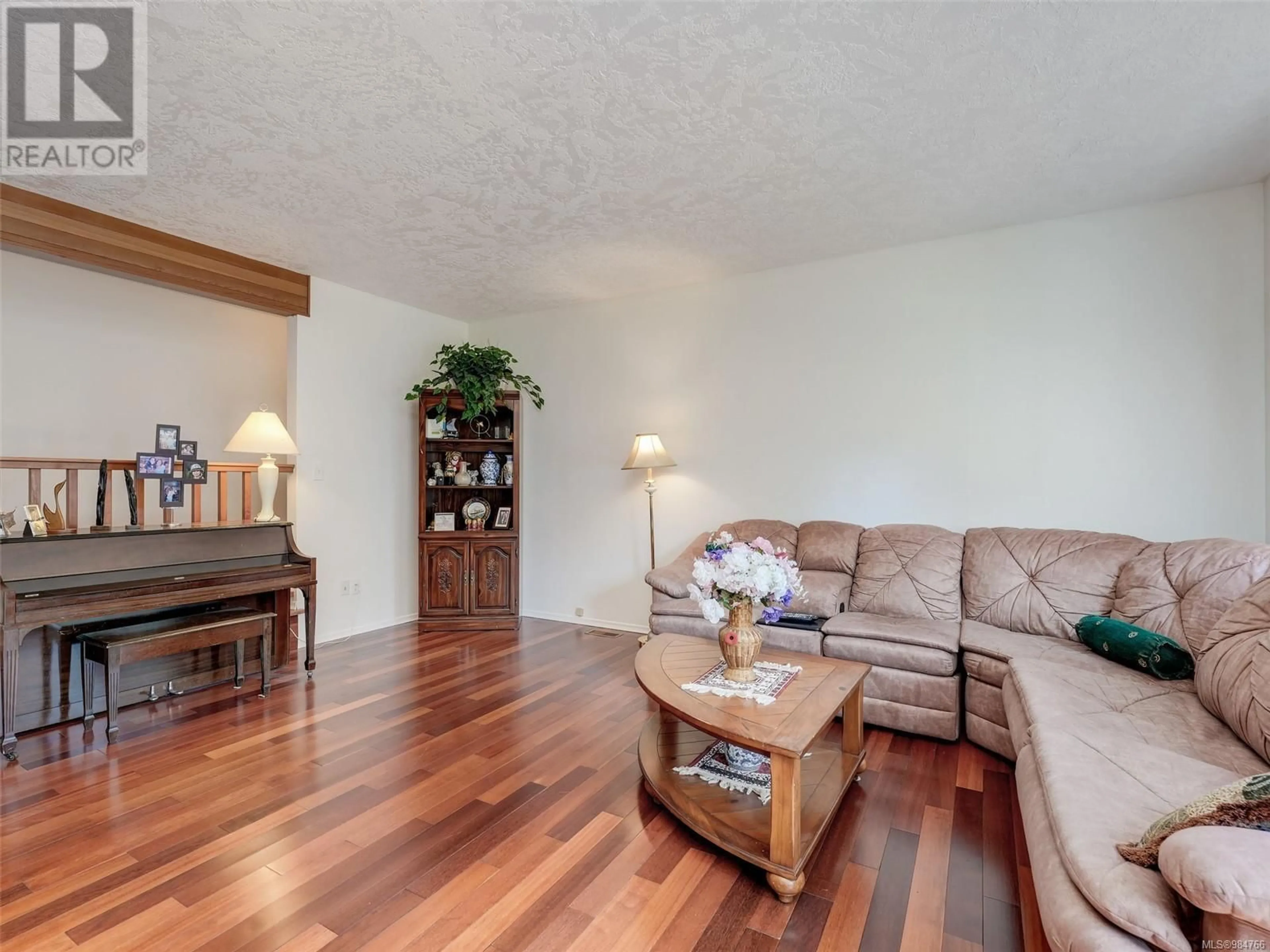 Living room with furniture, wood/laminate floor for 979 Royal Oak Dr, Saanich British Columbia V8X3T6