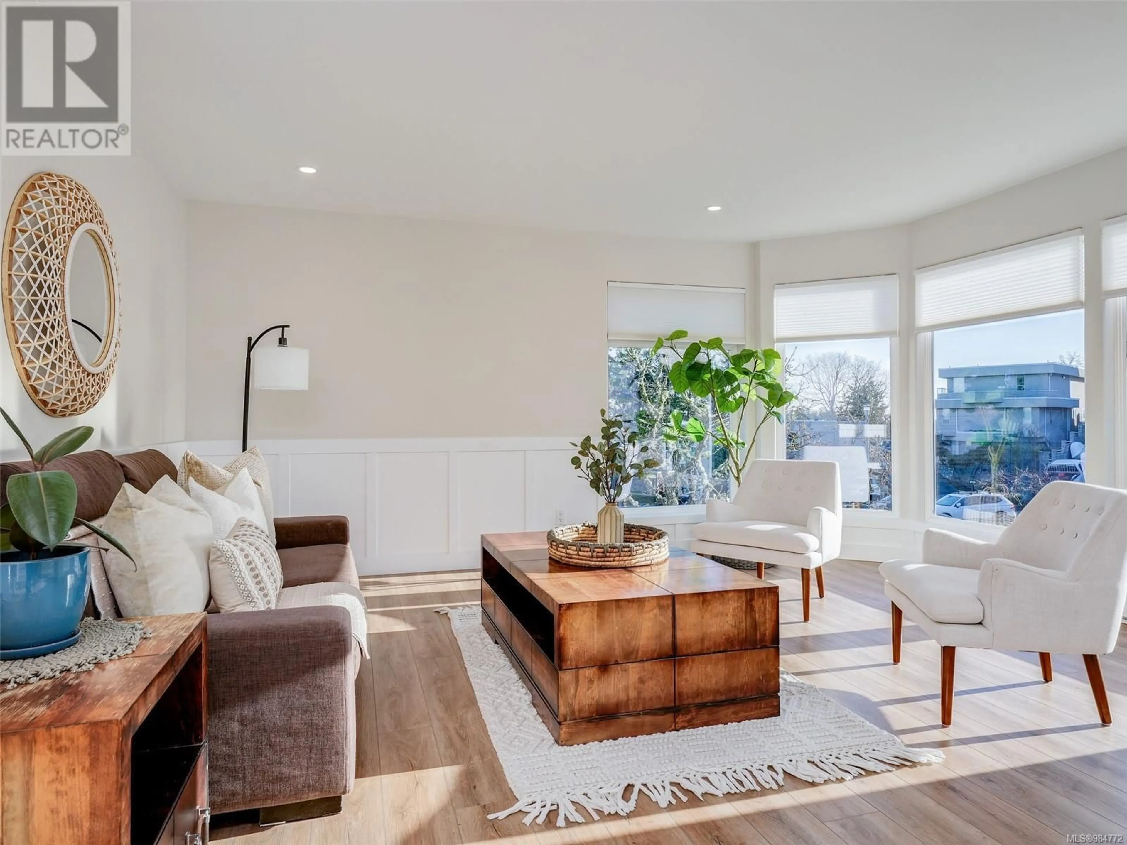 Living room with furniture, wood/laminate floor for 3922 Jean Hts, Saanich British Columbia V8Z7H2