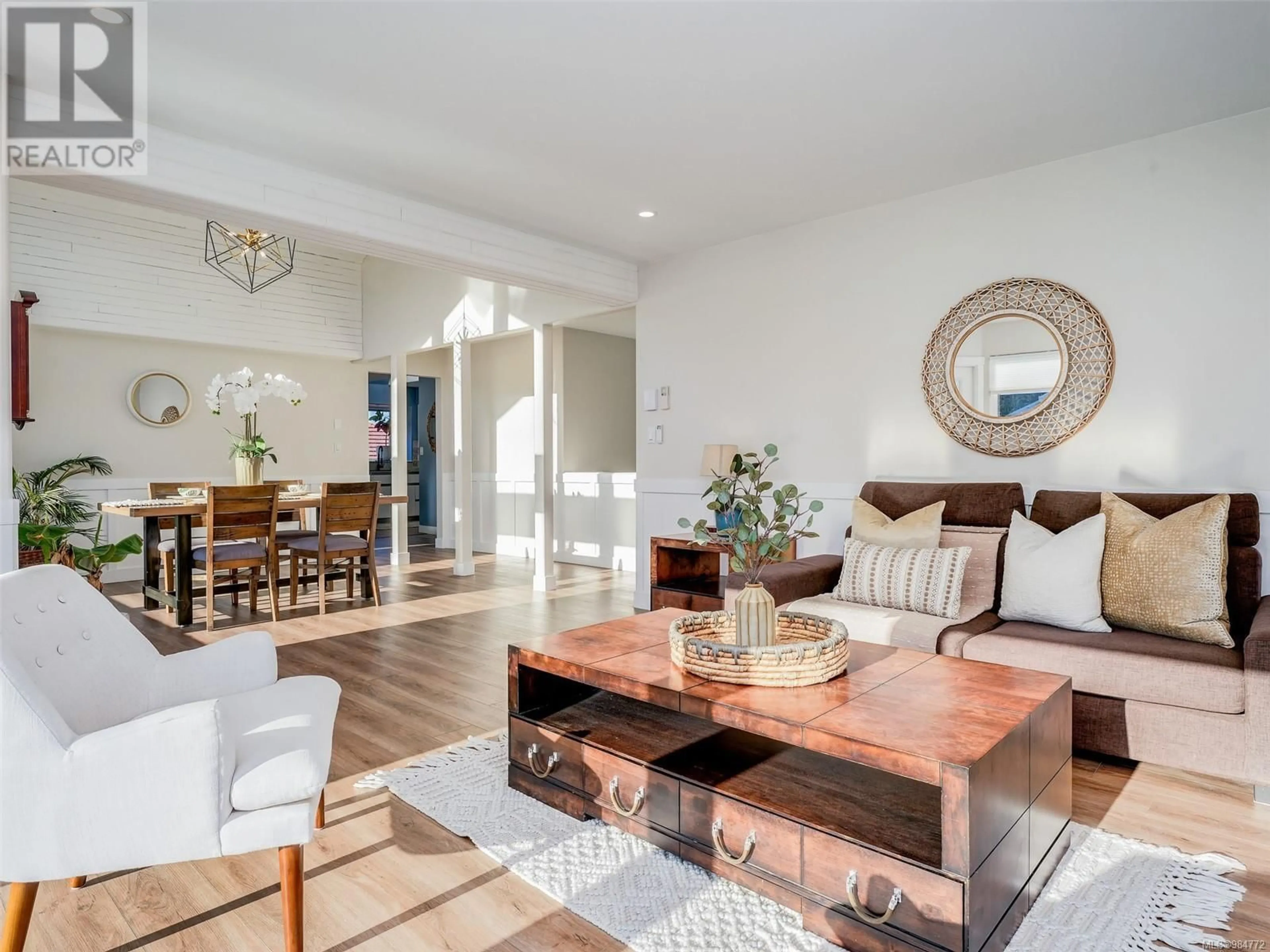 Living room with furniture, wood/laminate floor for 3922 Jean Hts, Saanich British Columbia V8Z7H2