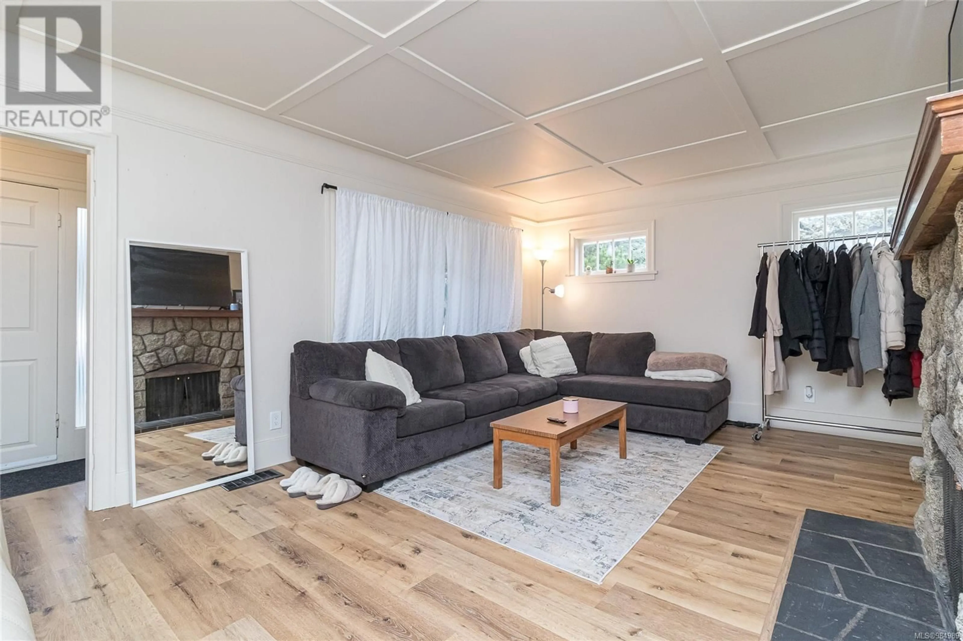 Living room with furniture, wood/laminate floor for 3364 Cook St, Saanich British Columbia V8X1A8