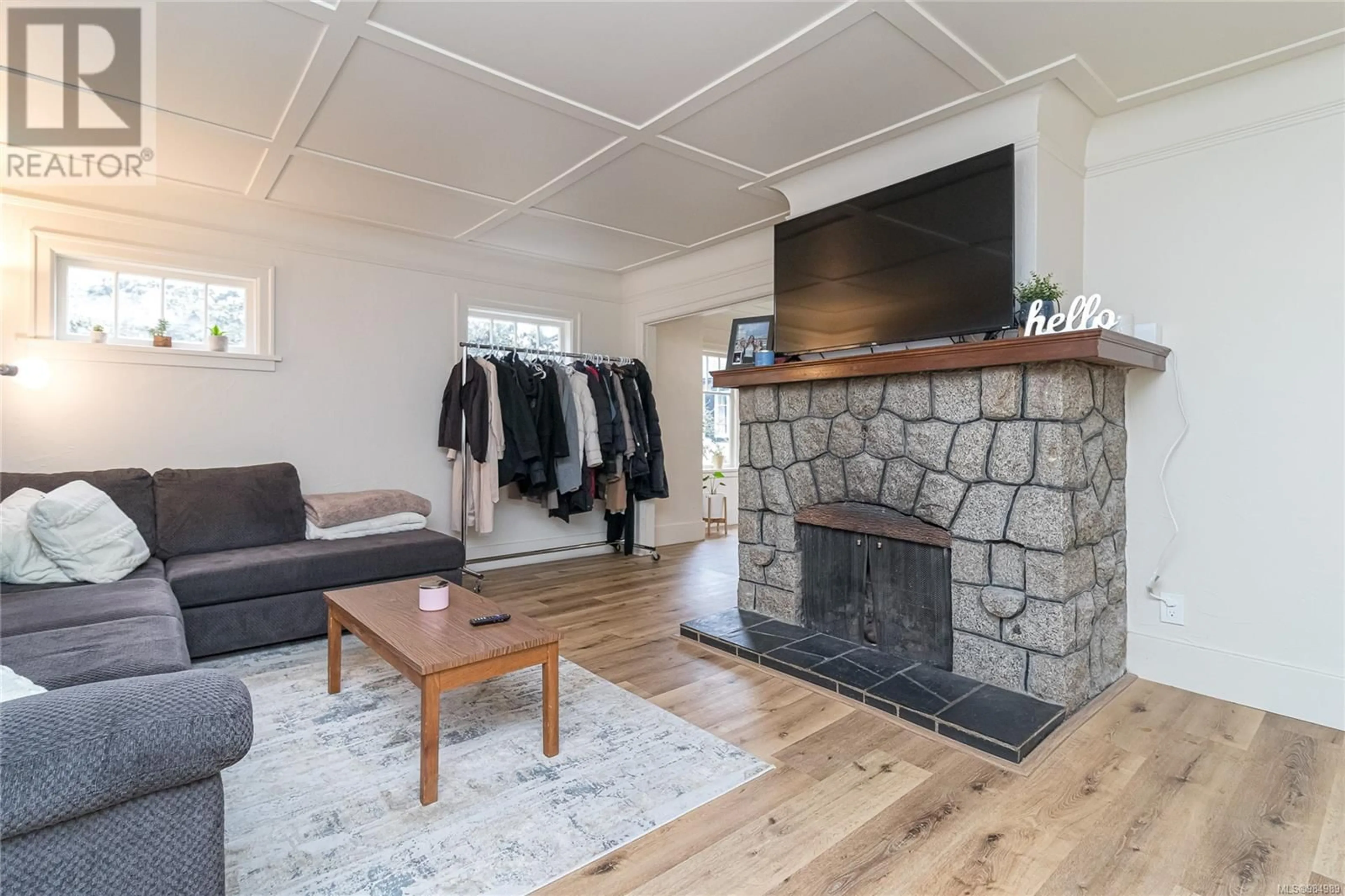 Living room with furniture, wood/laminate floor for 3364 Cook St, Saanich British Columbia V8X1A8