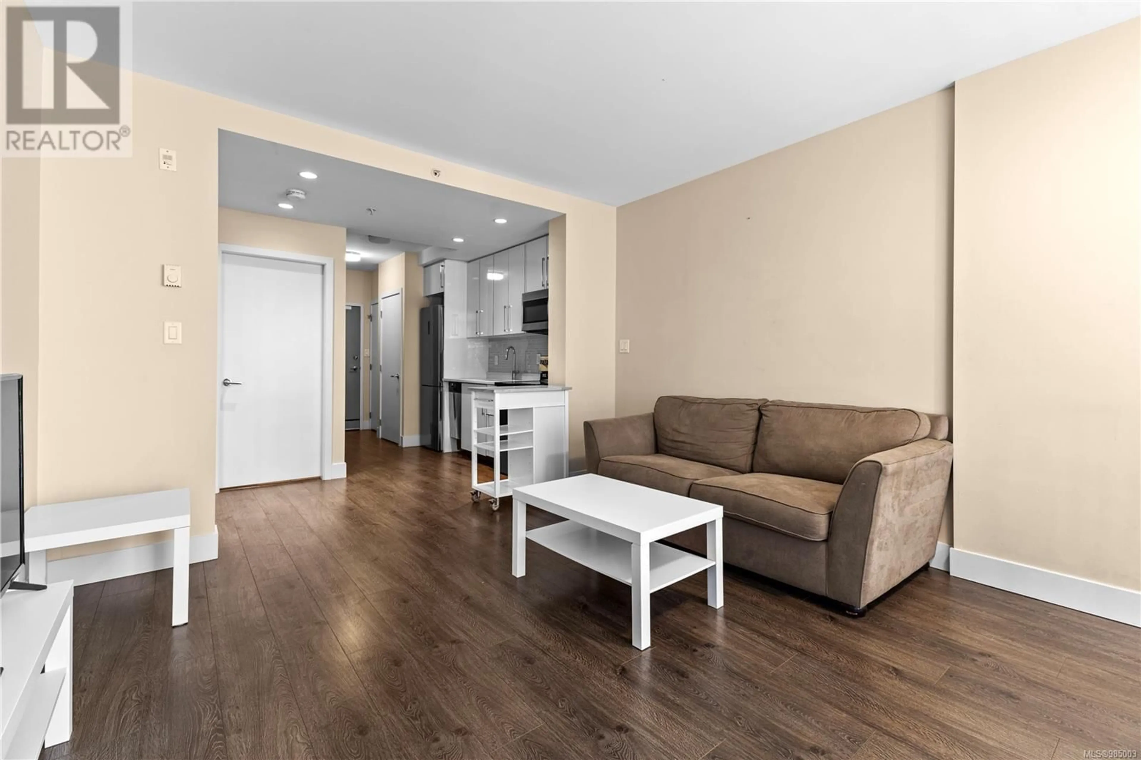 Living room with furniture, wood/laminate floor for 405 1090 Johnson St, Victoria British Columbia V8V0B3