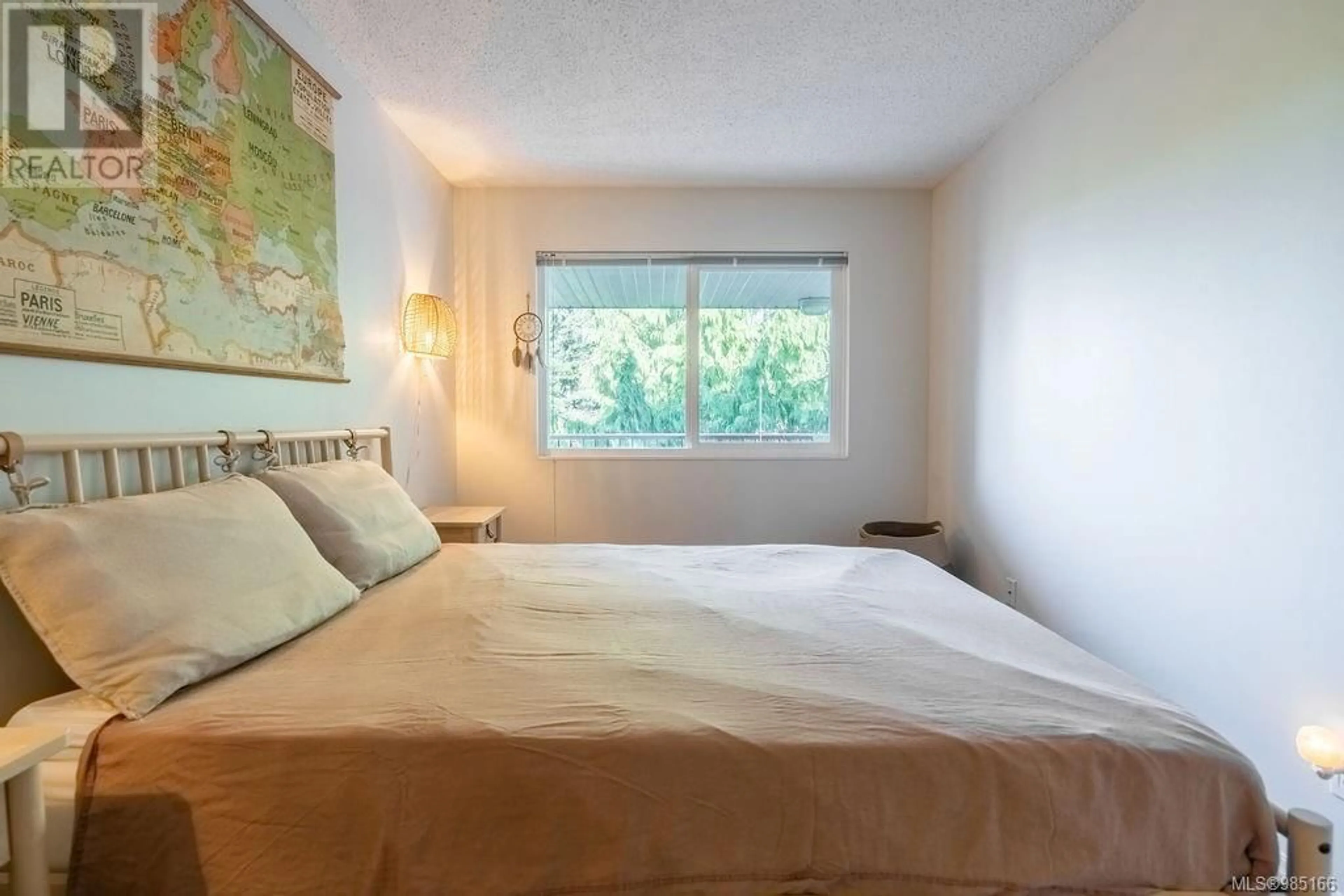 Bedroom with bed, wood/laminate floor for 402 250 Hemlock St, Ucluelet British Columbia V0R3A0