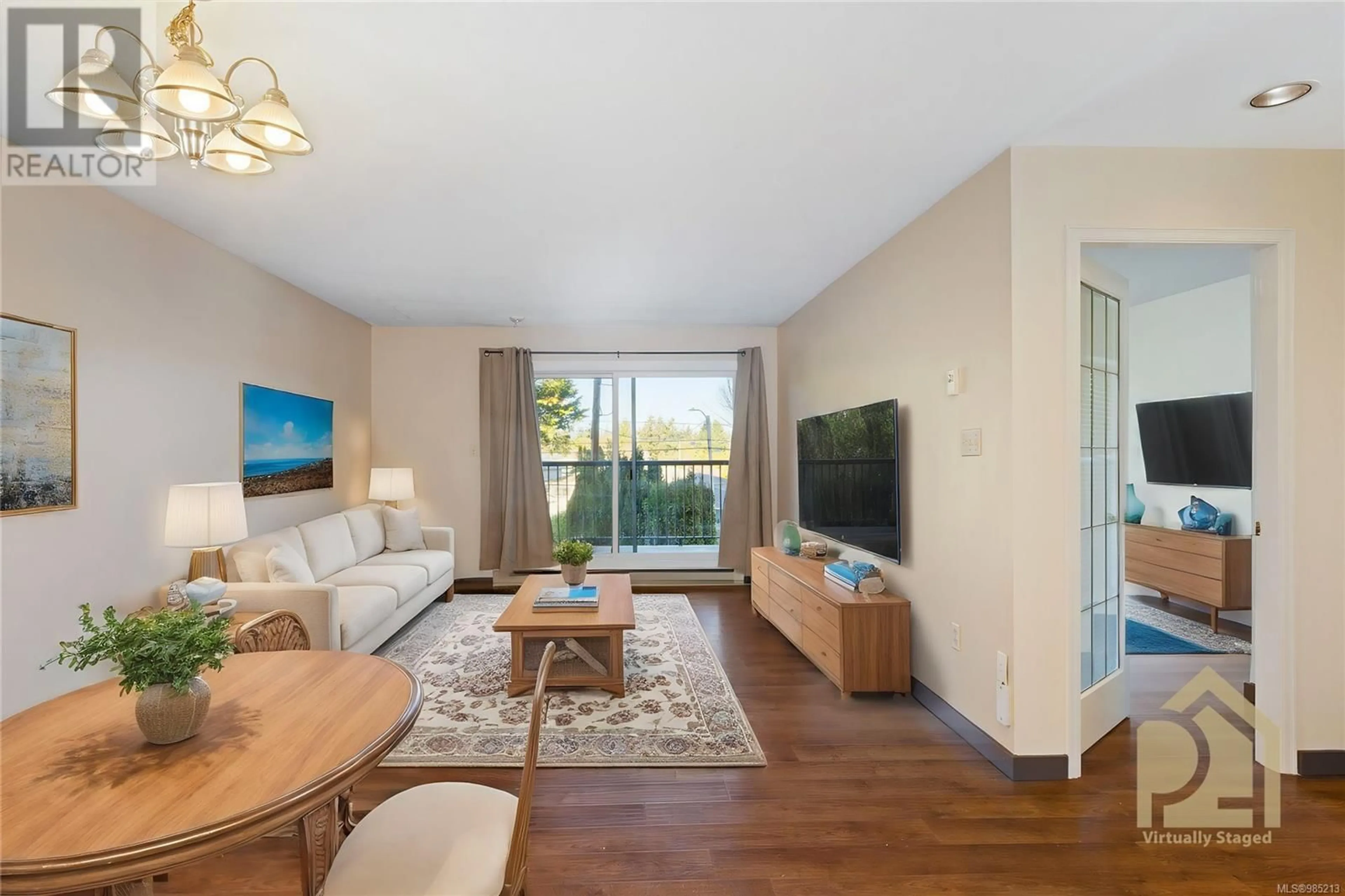 Living room with furniture, wood/laminate floor for 106 4030 Quadra St, Saanich British Columbia V8X1K2