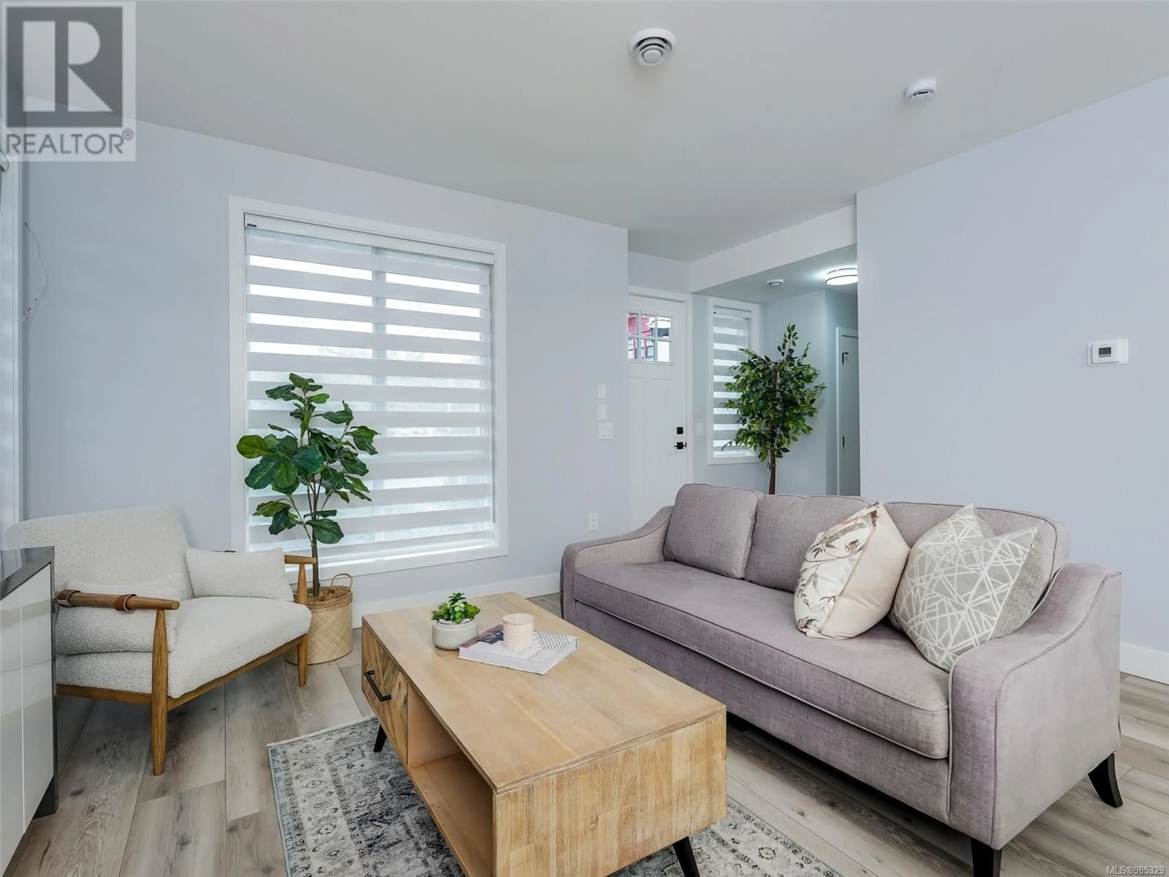 Living room with furniture, wood/laminate floor for 2 1171 Stelly's Cross Rd, Central Saanich British Columbia V8M1H4