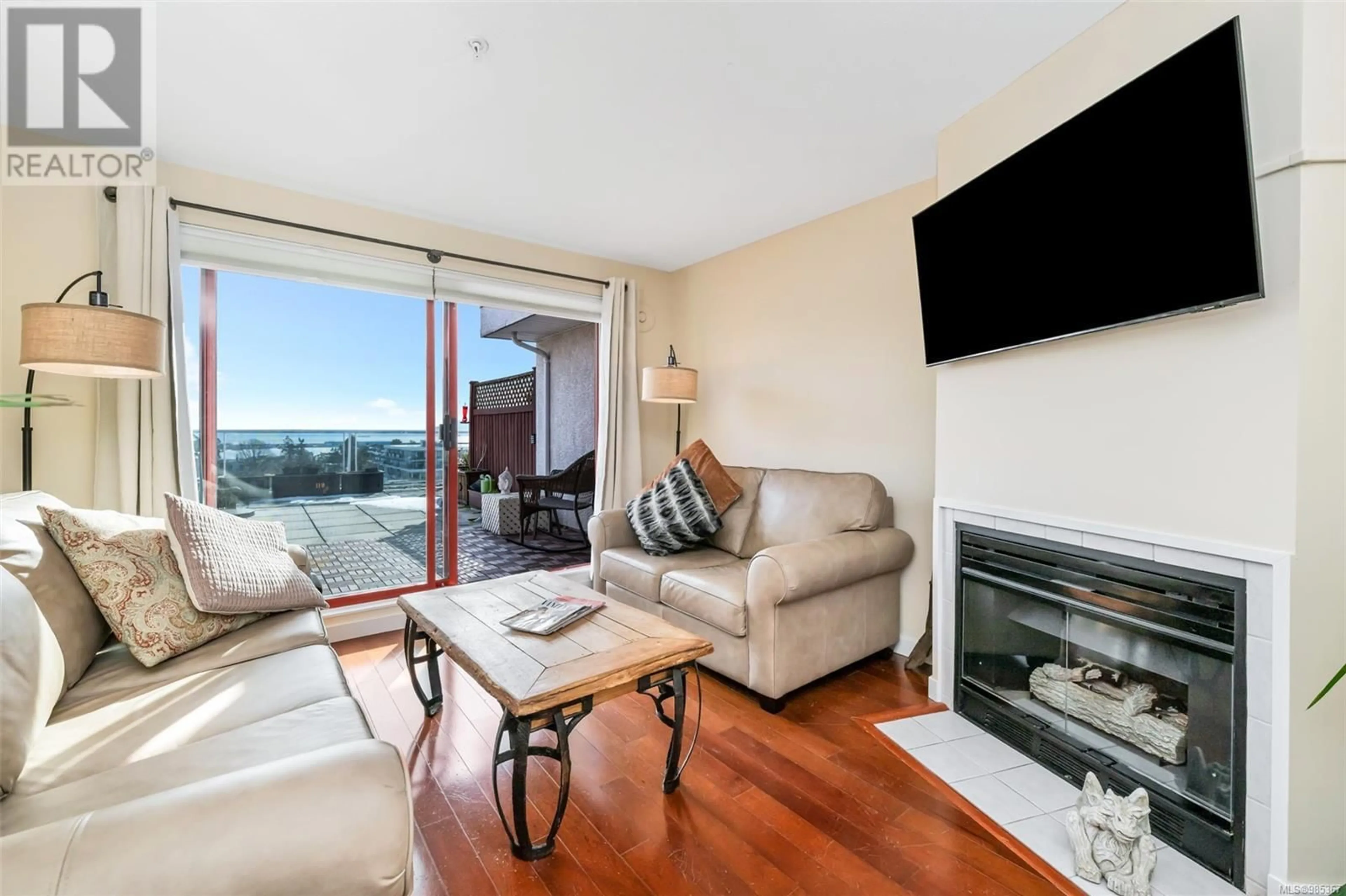 Living room with furniture, wood/laminate floor for 301 873 Esquimalt Rd, Esquimalt British Columbia V9A3M5