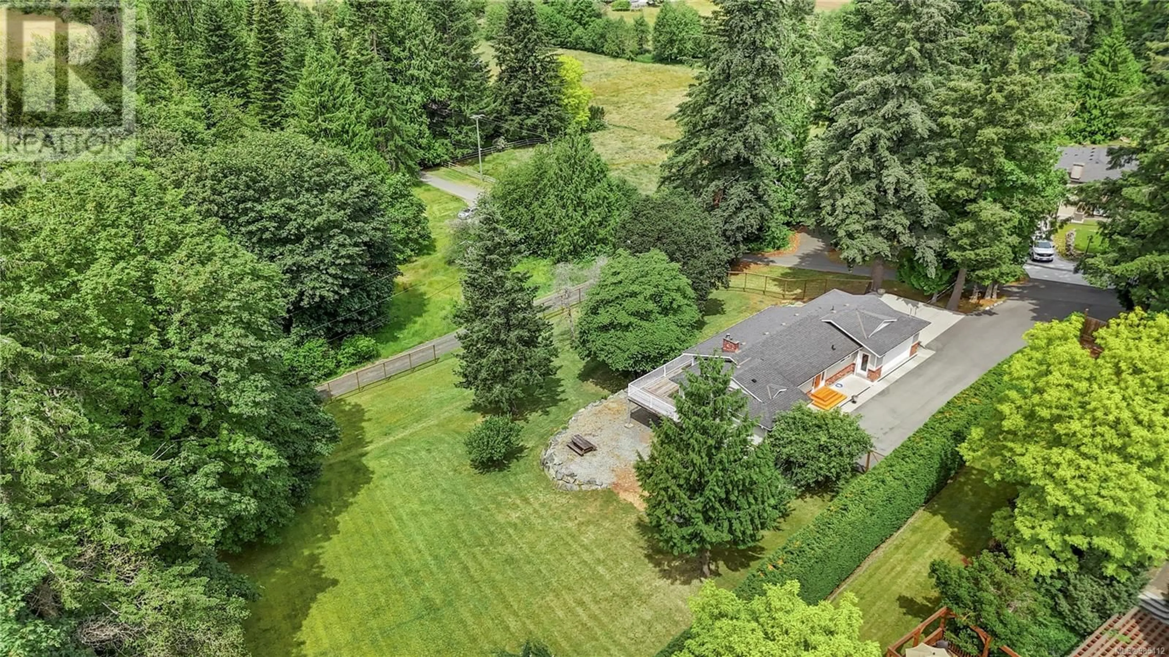 A pic from outside/outdoor area/front of a property/back of a property/a pic from drone, forest/trees view for 1751 Cultra Ave, Central Saanich British Columbia V8M1T1