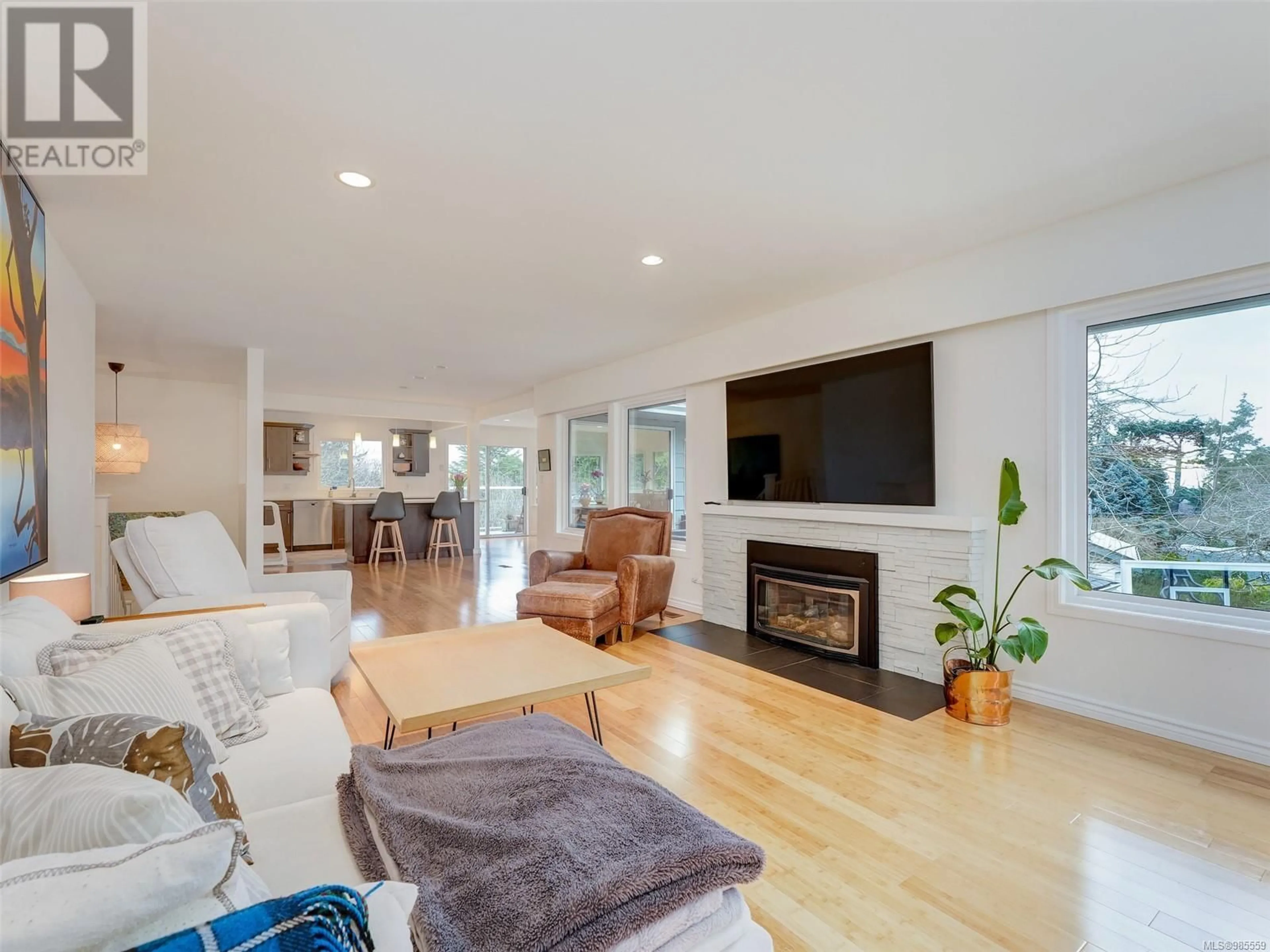 Living room with furniture, wood/laminate floor for 2174 Wenman Dr, Saanich British Columbia V8N2S2