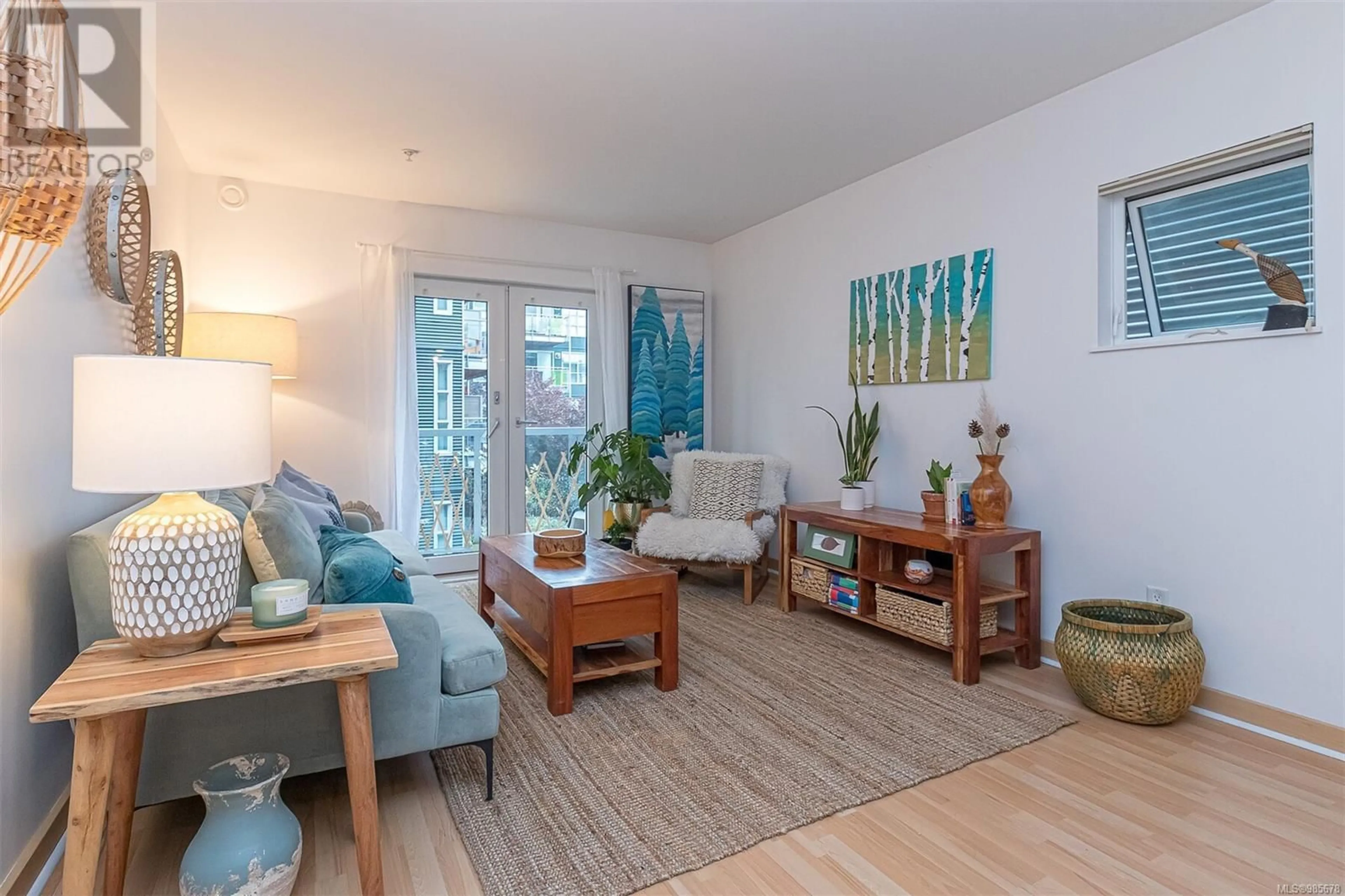 Living room with furniture, wood/laminate floor for 205 - 787 TYEE ROAD, Victoria British Columbia V9A7R5
