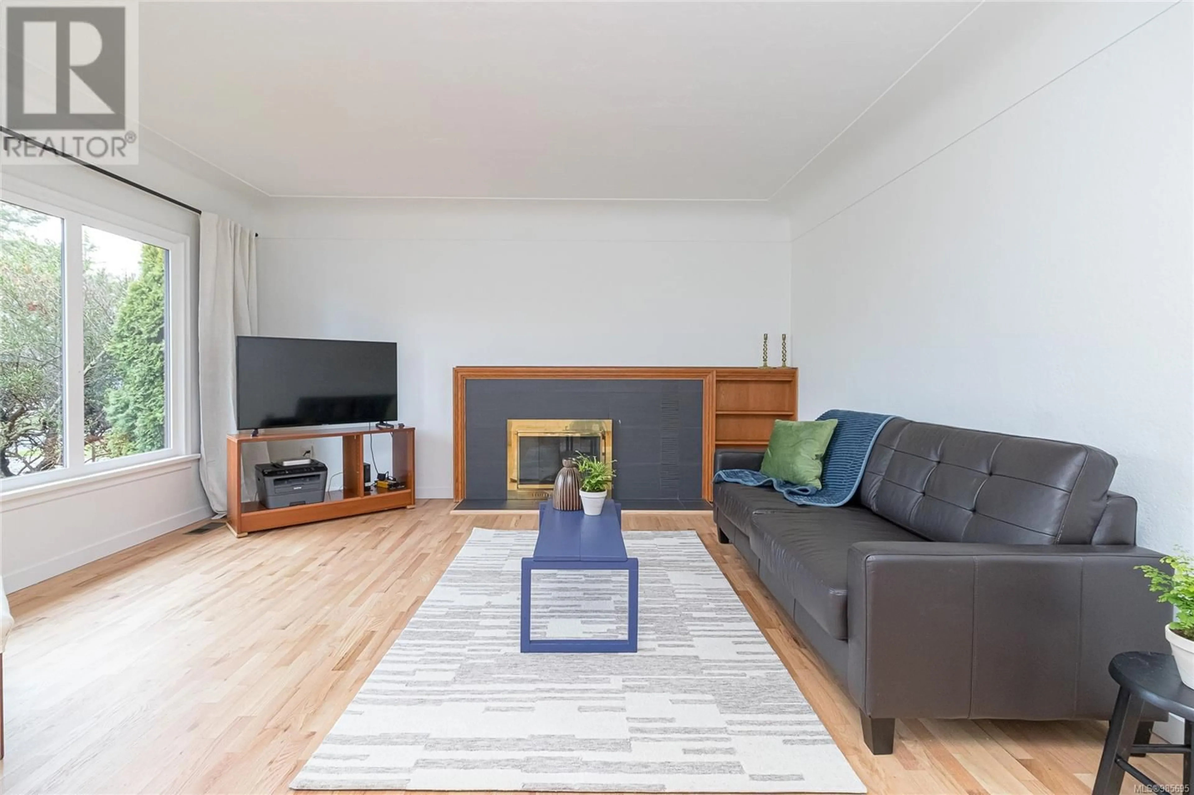 Living room with furniture, wood/laminate floor for 1867 Neil St, Saanich British Columbia V8R3C6