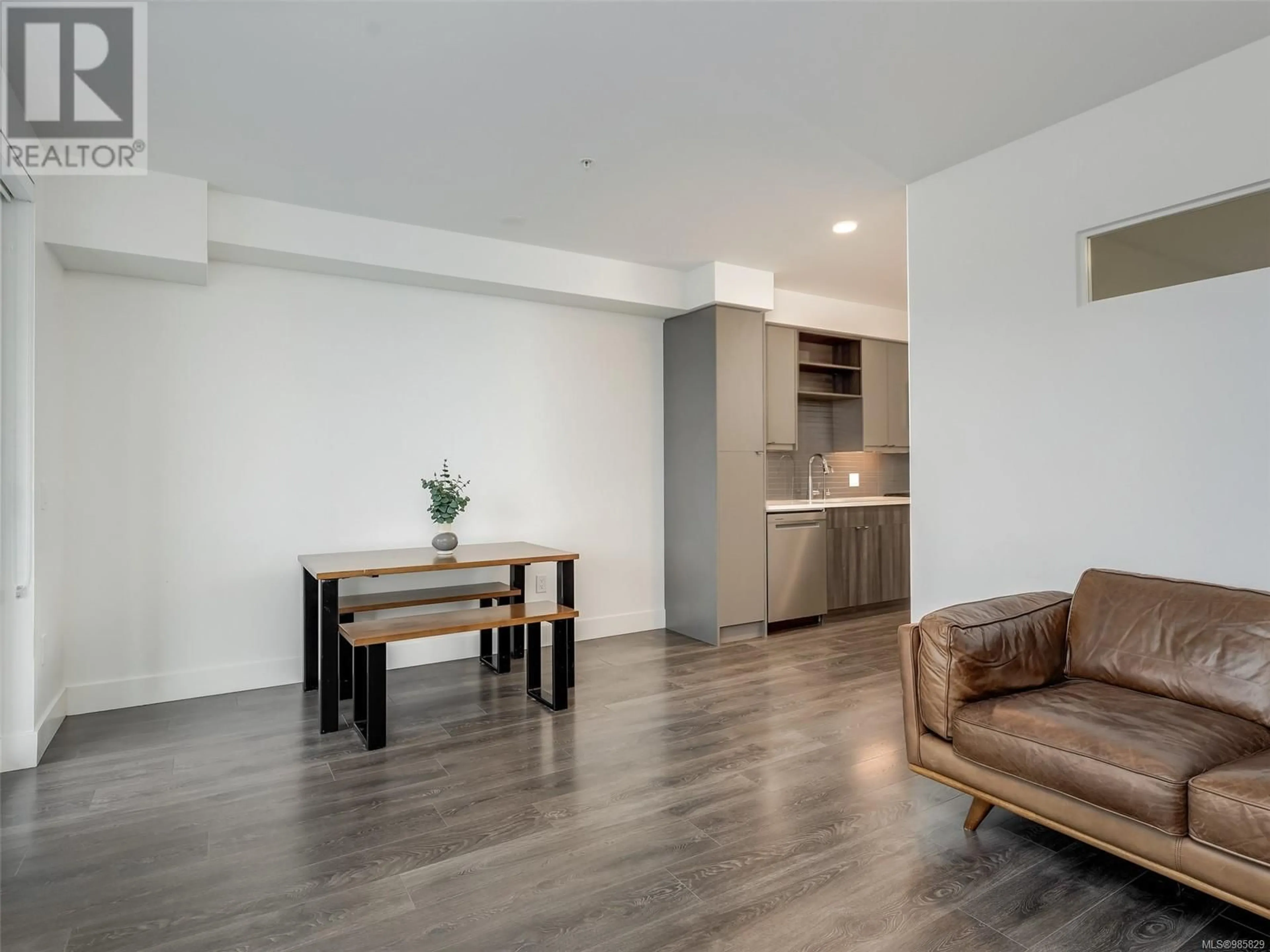 Living room with furniture, wood/laminate floor for 412 2461 Sidney Ave, Sidney British Columbia V8L1Y8