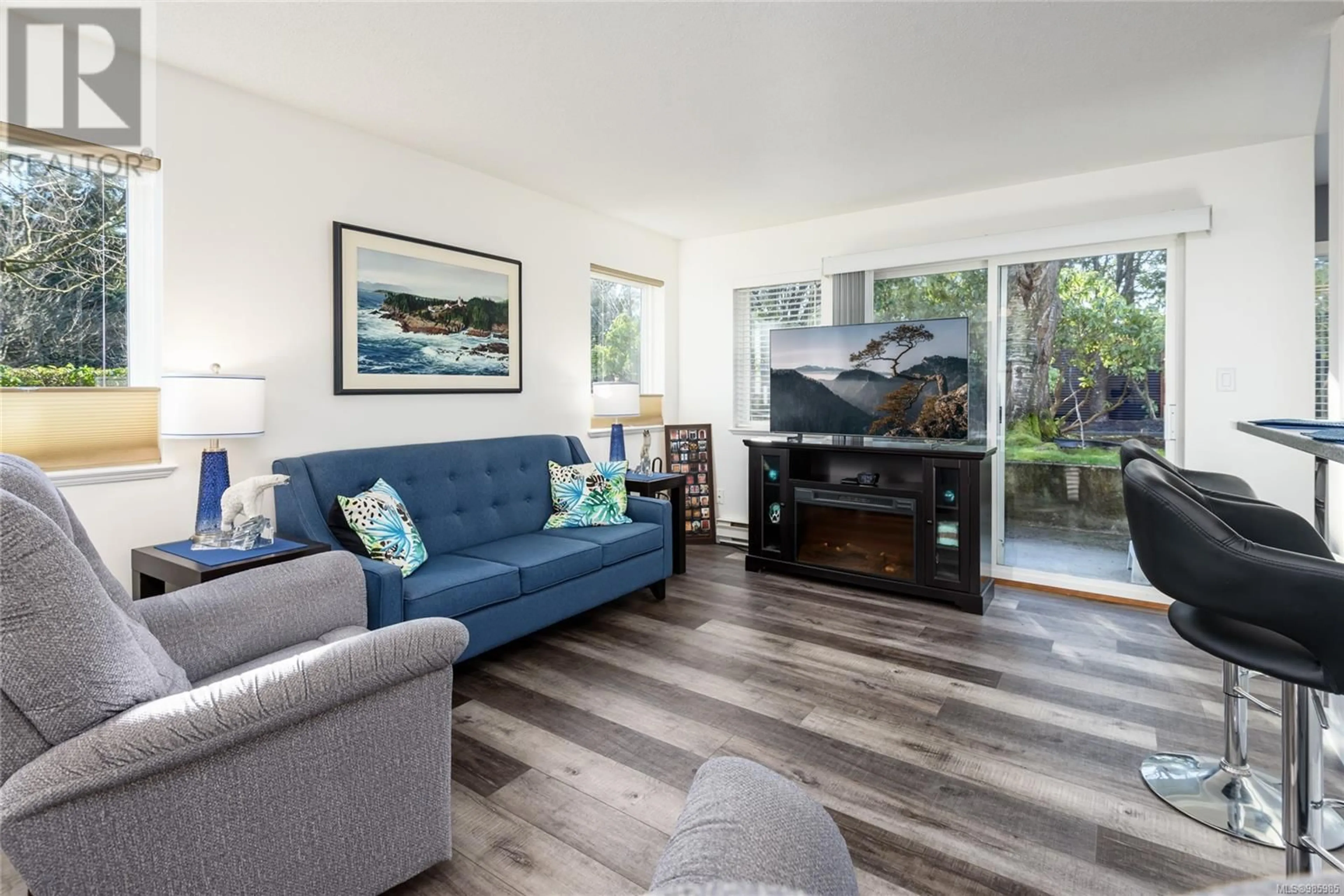 Living room with furniture, wood/laminate floor for 106C 698 Aspen Rd, Comox British Columbia V9M3S9