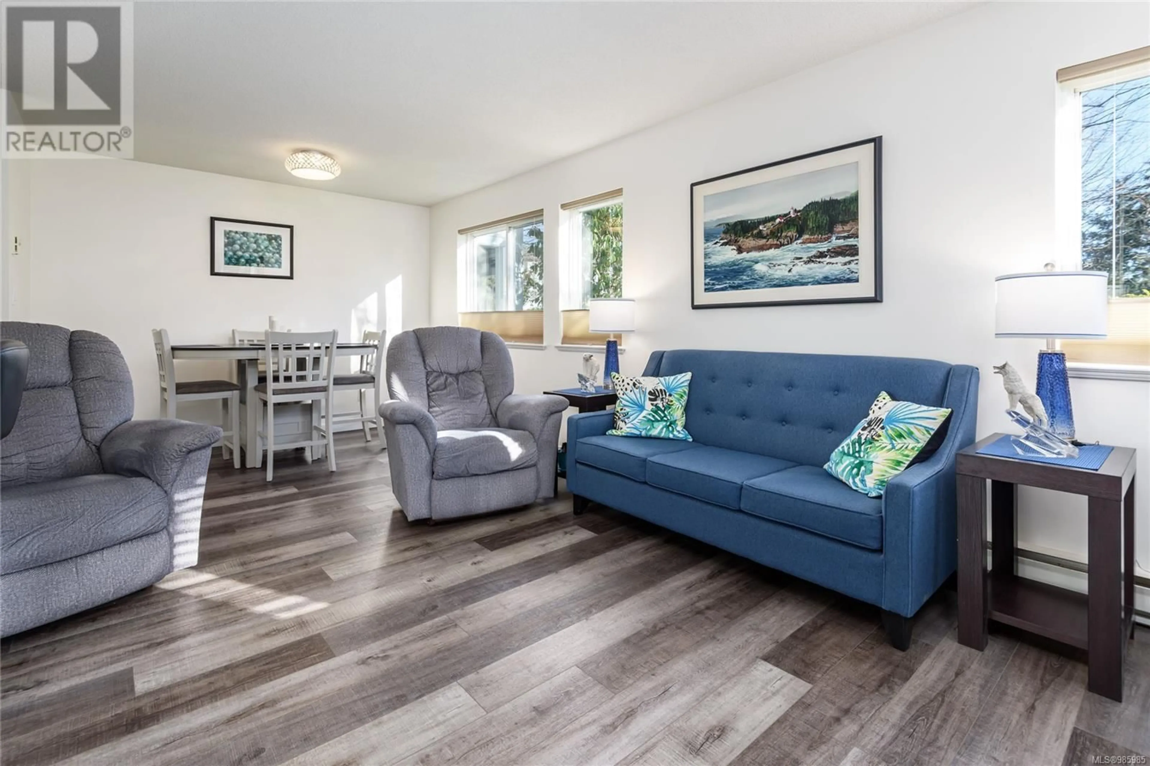 Living room with furniture, wood/laminate floor for 106C 698 Aspen Rd, Comox British Columbia V9M3S9