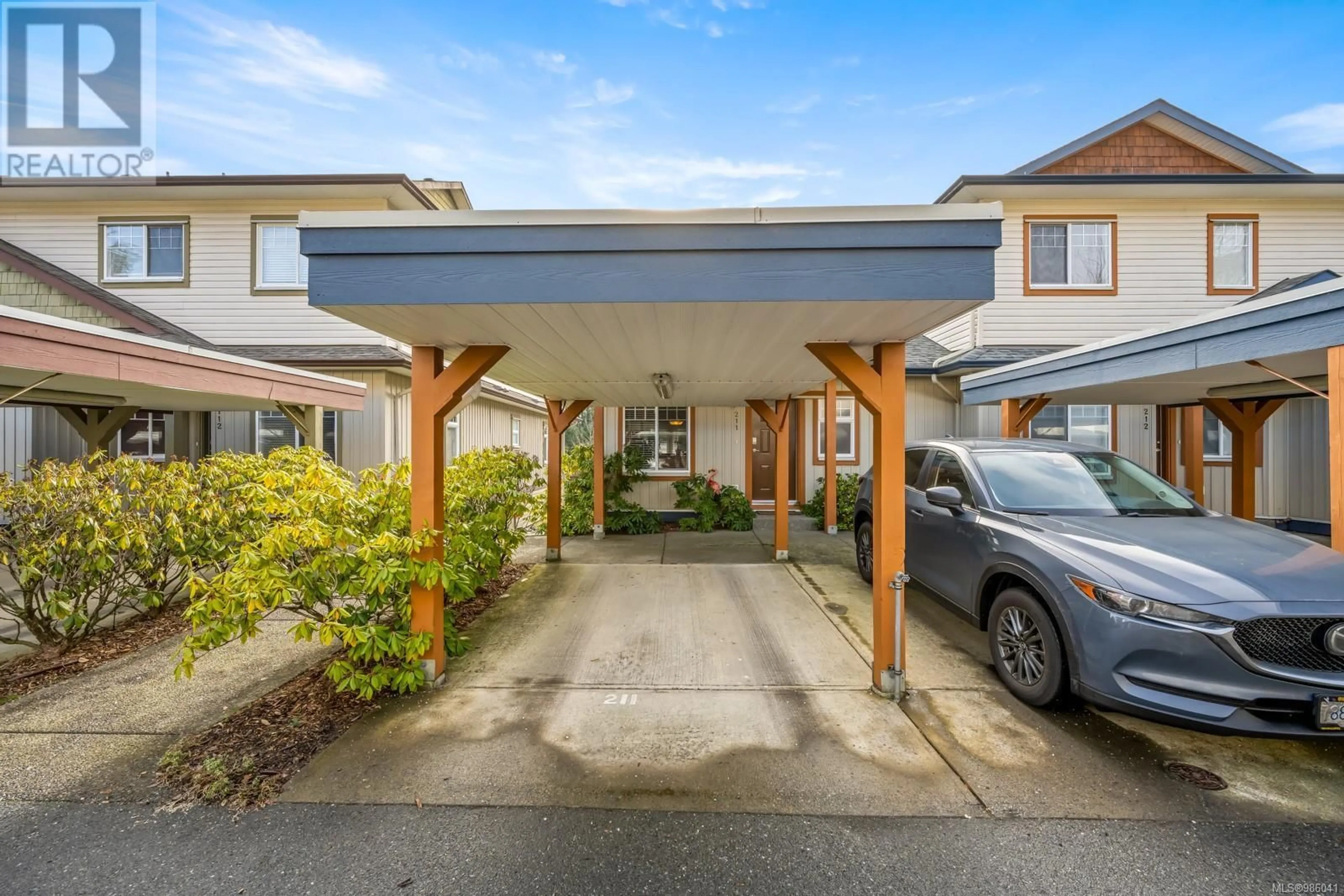 A pic from outside/outdoor area/front of a property/back of a property/a pic from drone, street for 211 930 Braidwood Rd, Courtenay British Columbia V9N3R9