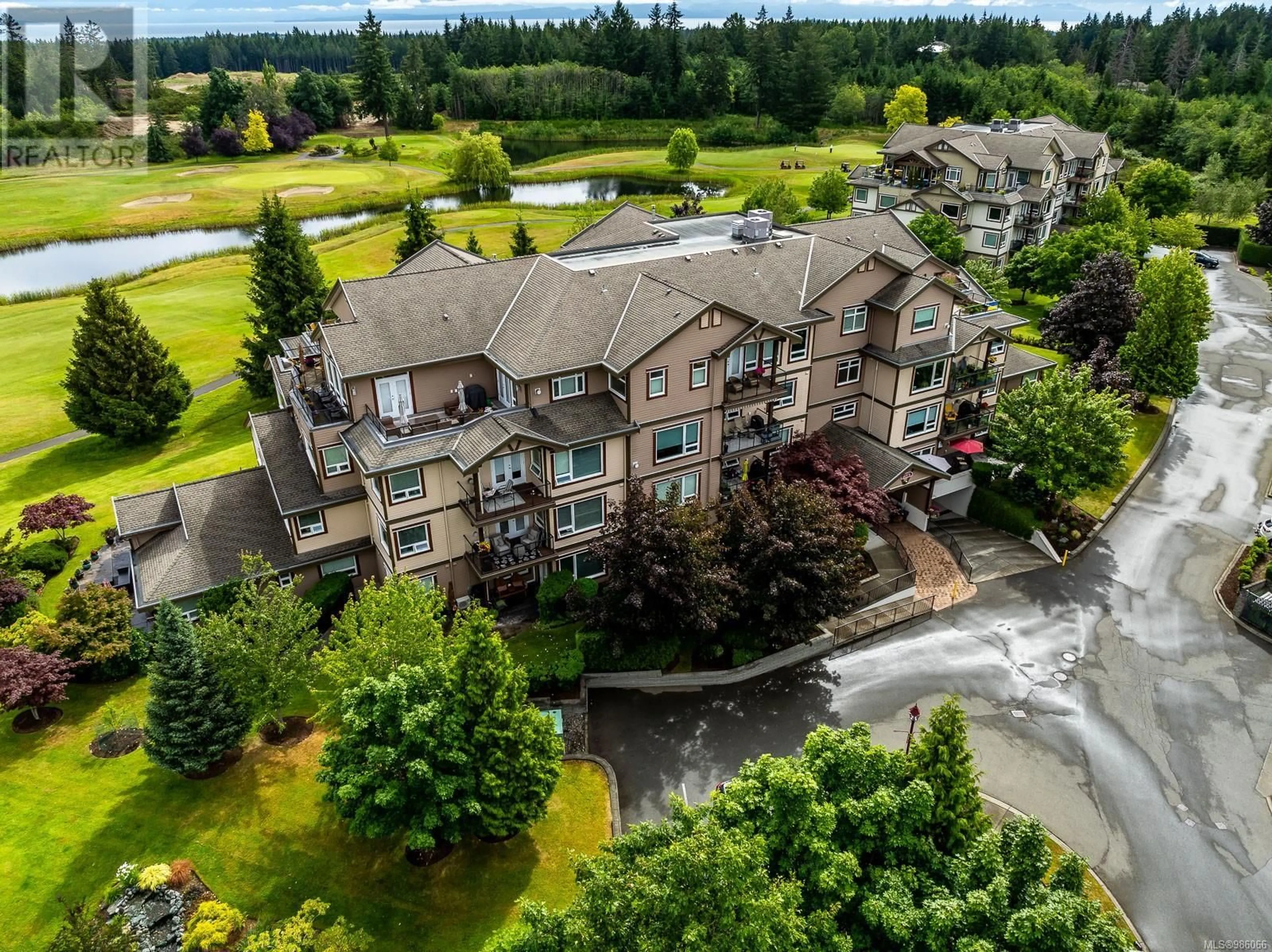 A pic from outside/outdoor area/front of a property/back of a property/a pic from drone, water/lake/river/ocean view for 316 3666 Royal Vista Way, Courtenay British Columbia V9N9X7