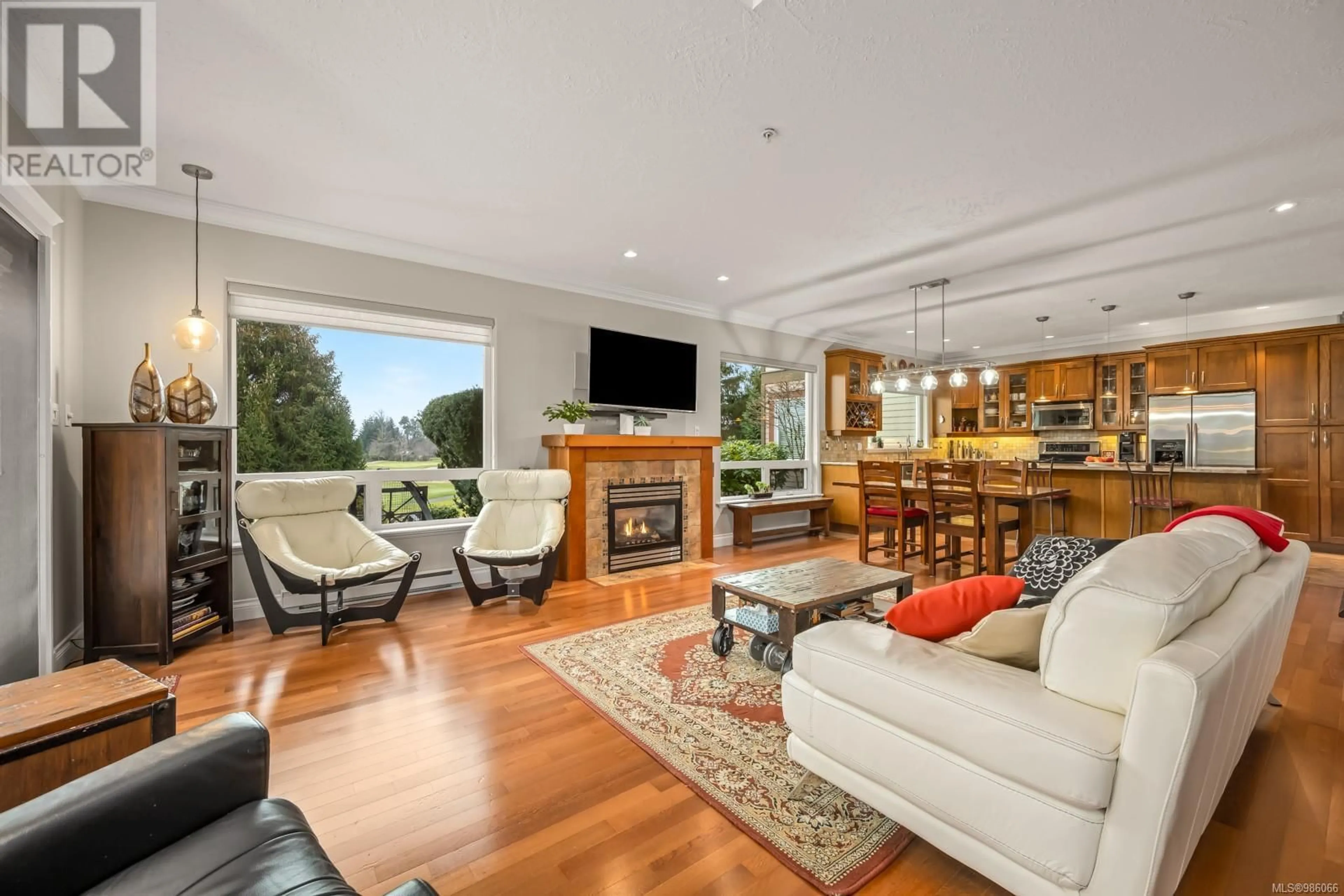 Living room with furniture, wood/laminate floor for 316 3666 Royal Vista Way, Courtenay British Columbia V9N9X7